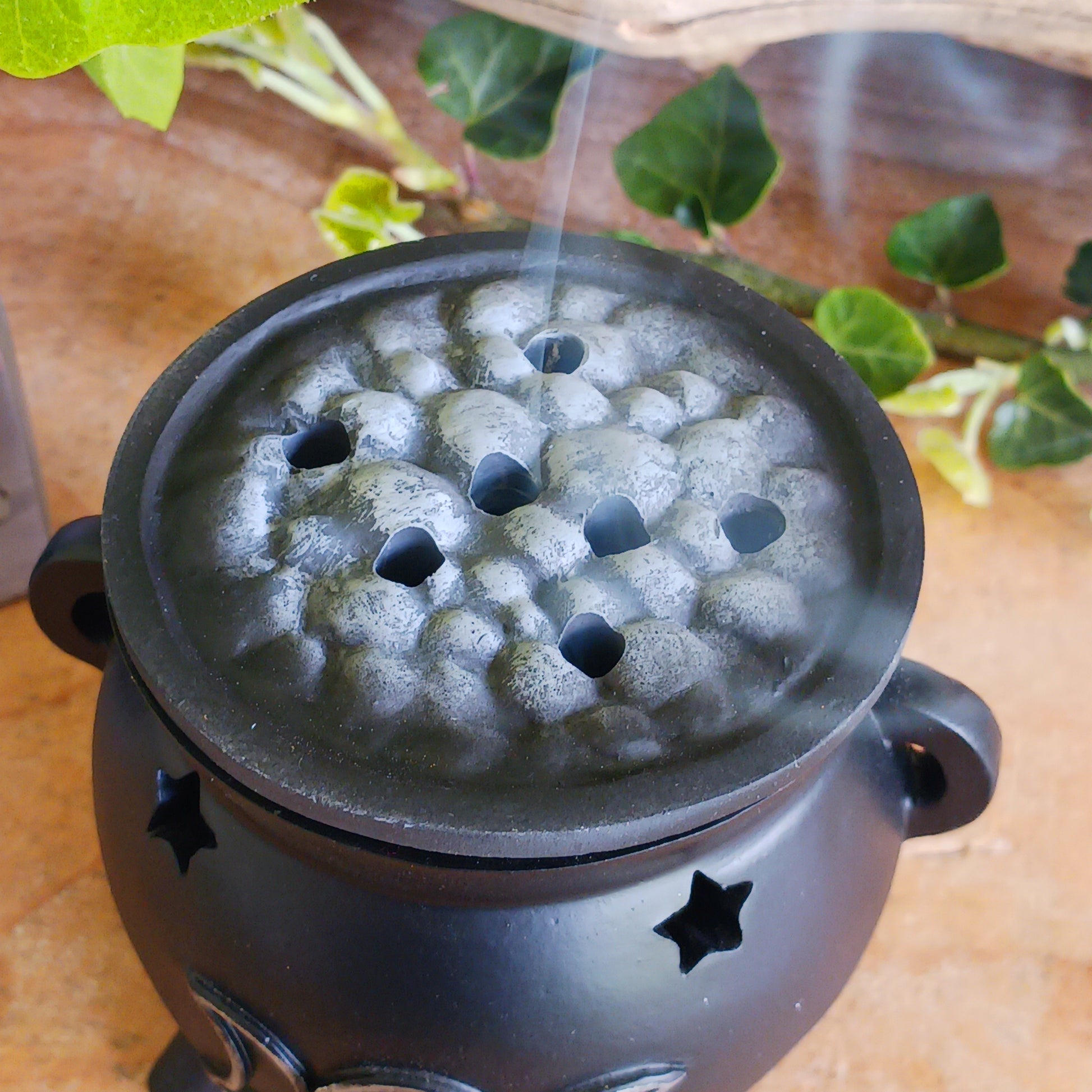 Create a mystical atmosphere in your space with this beautifully crafted Triple Moon Cauldron Incense Burner. Designed for both function and aesthetic appeal, this enchanting resin burner allows you to place an incense cone inside and watch as fragrant smoke gently rises through the top, creating a calming and magical ambiance.