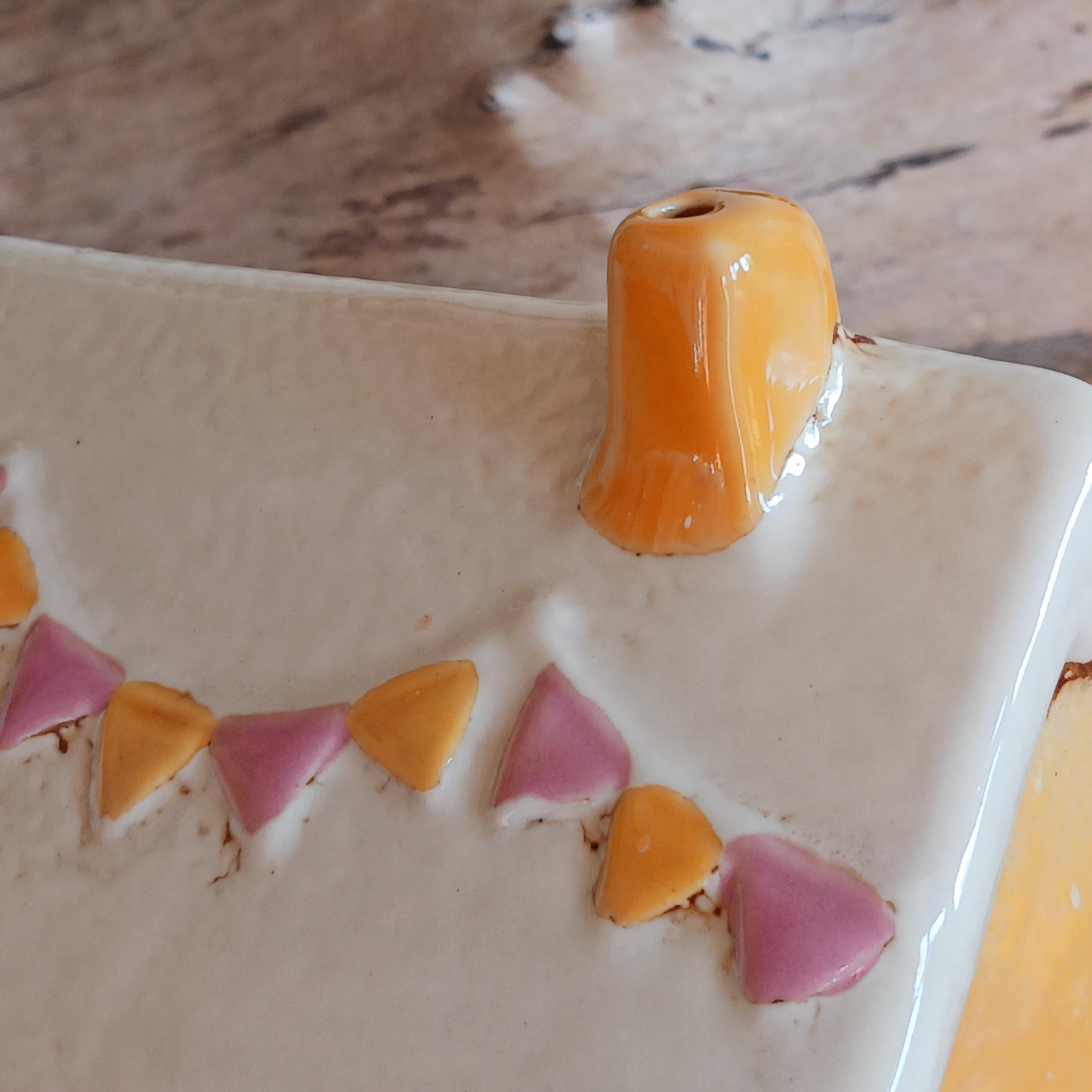 Add a whimsical touch to your décor with the Cards &amp; Gifts Tealight Holder from the Village Pottery Collection. Inspired by the charm of a cozy card shop in a quaint village, this ceramic piece features intricate detailing, from its bunting roof to its delicate windows. Perfect as a tealight holder or simply as a decorative ornament, it brings warmth and character to any space.