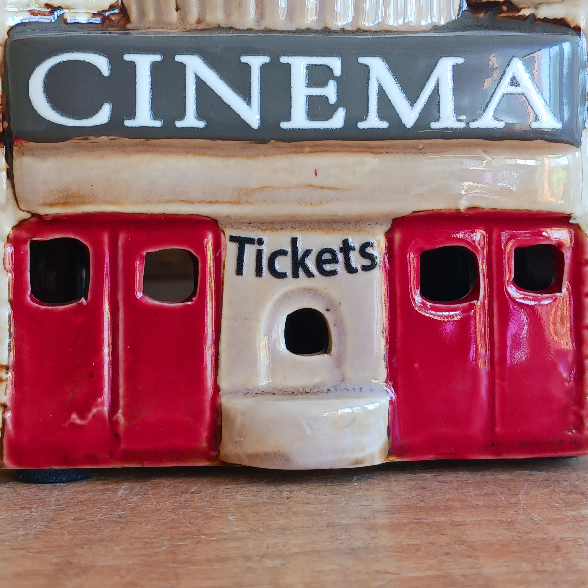Step into a twilight screening where candlelight flickers like scenes upon an unseen reel. The Shudehill Village Pottery Roxy Cinema tealight house is crafted from ceramic, casting a soft glow through its windows to evoke a nostalgic yet enchanted village night.