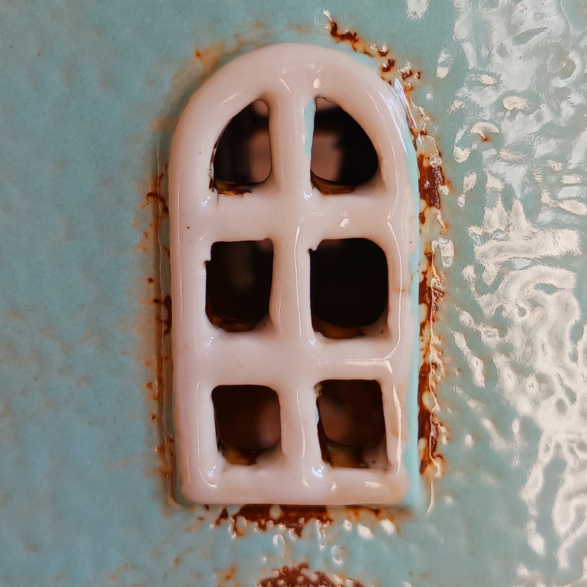 Transform your home into a warm and inviting sanctuary with the Village Pottery Gift Shop Tealight Holder. Crafted from quality ceramic, this charming piece creates a cosy, nostalgic glow when lit with a tealight. More than just a candle holder, it doubles as a delightful decorative ornament for your coffee table, shelf, or windowsill.