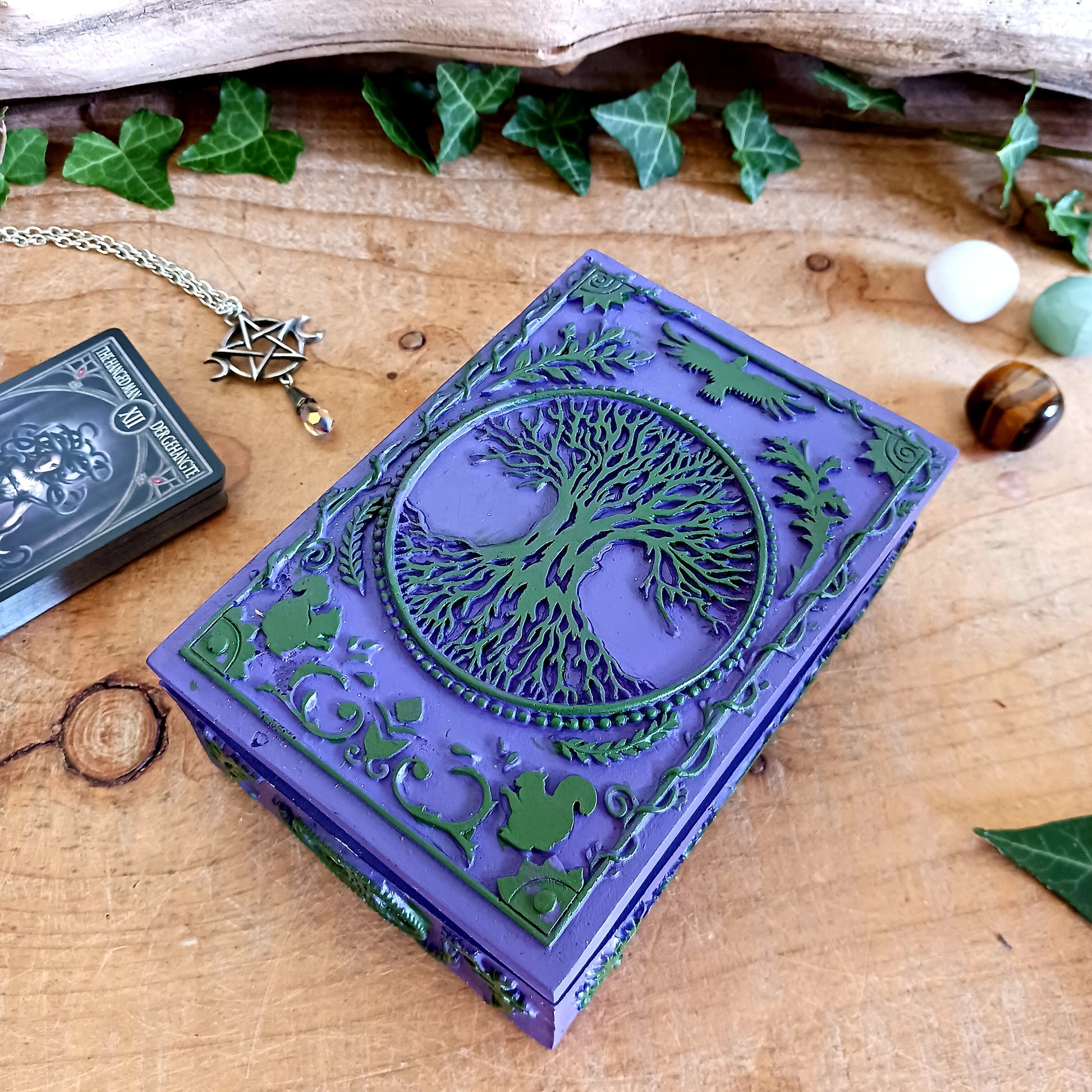 Bring magic, beauty, and function to your space with this exquisite hand-painted Tree of Life Wooden Box. Perfect for housing Tarot or Oracle decks, storing jewellery, trinkets, herbs, sage, spells, Feng Shui items, incense, stamps, and more, this vibrant box is as versatile as it is beautiful. The intricate Tree of Life design adds spiritual symbolism and charm, making it a stunning statement piece for your altar, desk, or shelf.
