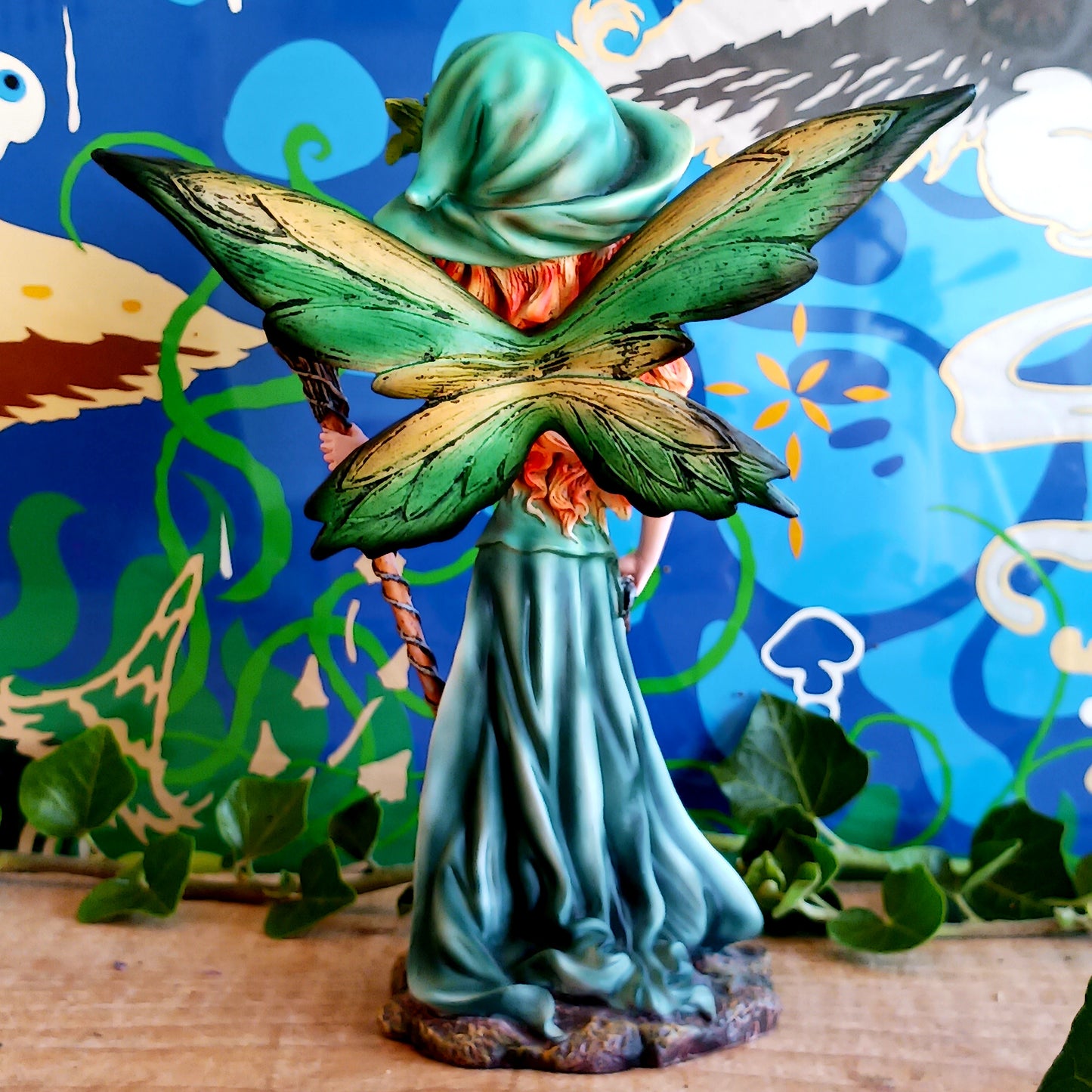 Meet Forest Fae, the whimsical guardian of the woods. This stunning standing fairy figurine captures the perfect blend of natural beauty and kawaii charm. Hand-painted with exquisite detail, she wears a lush forest green outfit, accented by leaf-shaped brooches, and holds a mystical staff crowned with a purple jewel. 