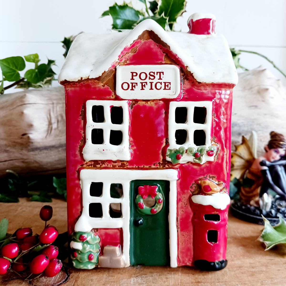 Create a cosy Christmas village scene with this charming Village Pottery Christmas Post Office Tealight Holder. Beautifully detailed as a traditional snowy village post office, it features a snow-covered roof, a post box and a delightful robin decoration for a wonderfully festive look.