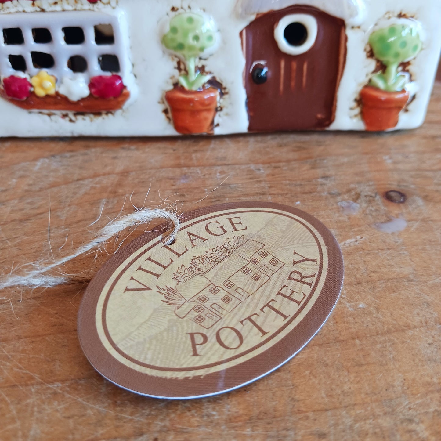 Illuminate your home with the charming Red Lion Pub Tealight Holder from the Village Pottery Collection. Crafted from quality ceramic, this delightful tealight holder adds warmth and character to any space. Perfect for creating your own enchanting village scene, it’s both a functional tealight holder and a decorative ornament.