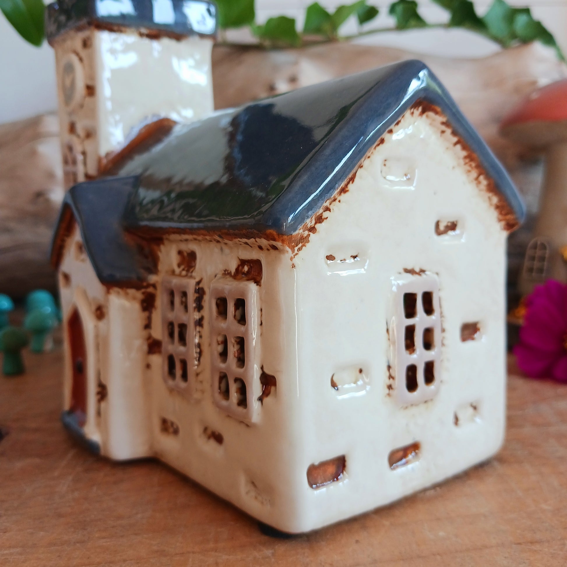 Add timeless charm to your home with the Village Pottery Steeple Church Tealight Holder. Beautifully hand-finished, each ceramic piece is unique and full of character. When a tealight is placed inside, a warm, cosy glow shines through the delicate church windows, creating a magical ambiance. 