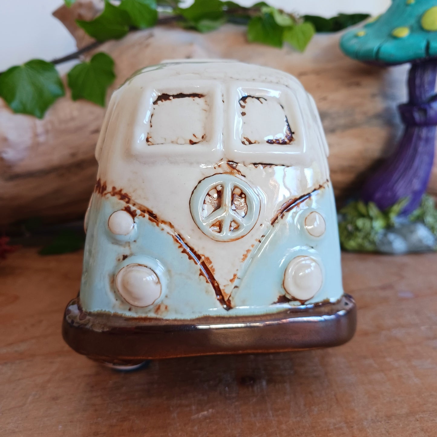 From the enchanted lanes of Village Pottery comes this Aqua VW Campervan Money Box, a charming ceramic treasure crafted for dreamers and wanderers alike. Measuring 11 x 18.5 x 10cm, this delightful piece captures the spirit of adventure with its soft aqua glaze, vintage VW Campervan design, and hand-painted detailing that feels kissed by fairy dust.