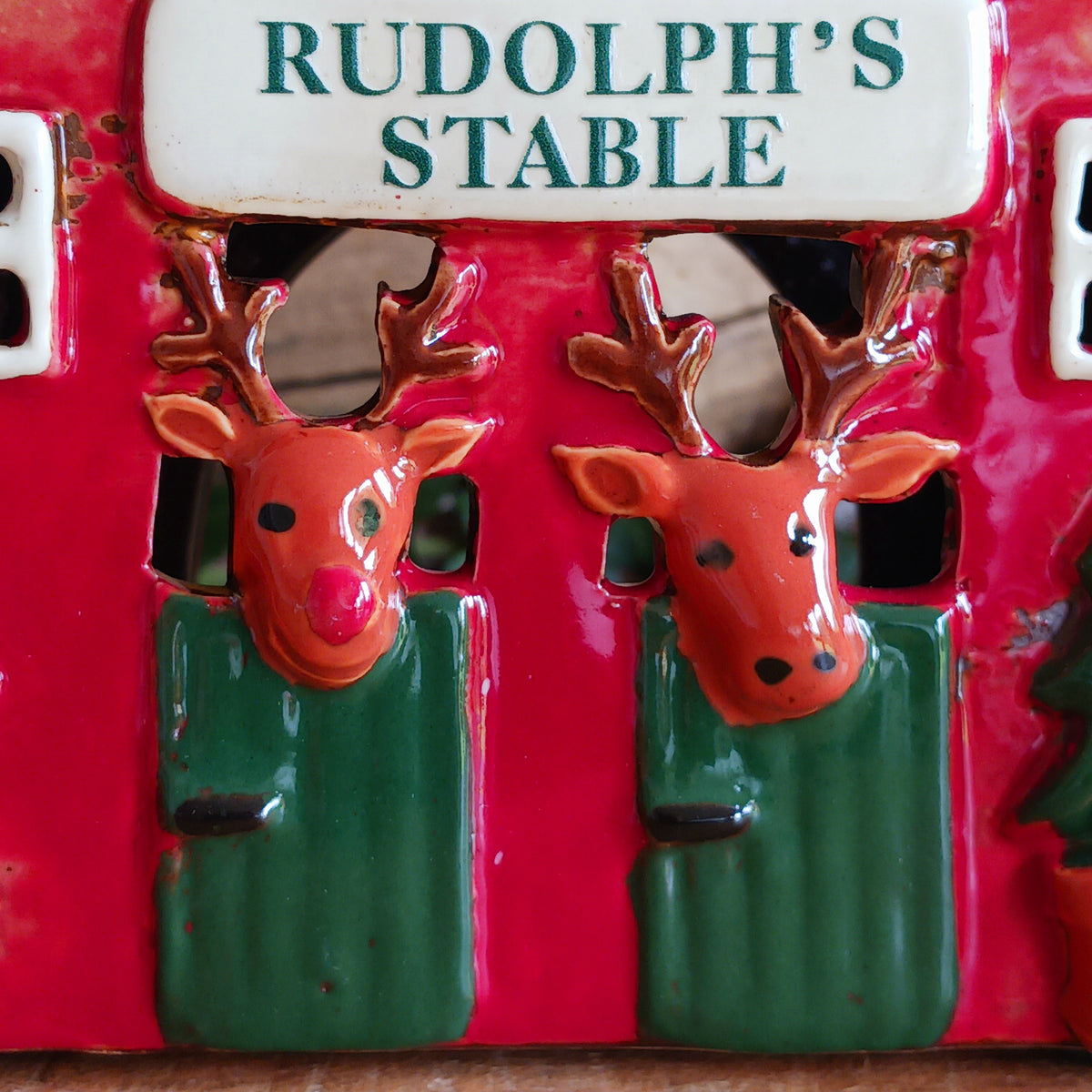 Bring a touch of festive village charm to your home with the Village Pottery Xmas Rudolph’s Stable Tealight Holder. This delightful ceramic Christmas decoration is designed as a quaint little stable, featuring a snowy roof, traditional green doors and charming reindeer detailing.