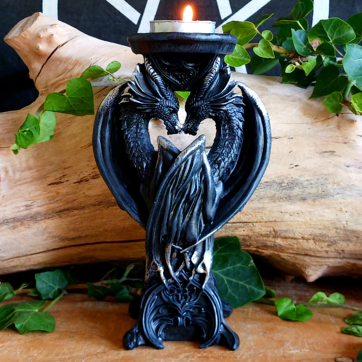 Add a touch of mythical drama to your home with the Dark Heart Candle Holder, a beautifully crafted fantasy ornament featuring two dragons lovingly positioned head-to-head to hold a single tealight or pillar candle.