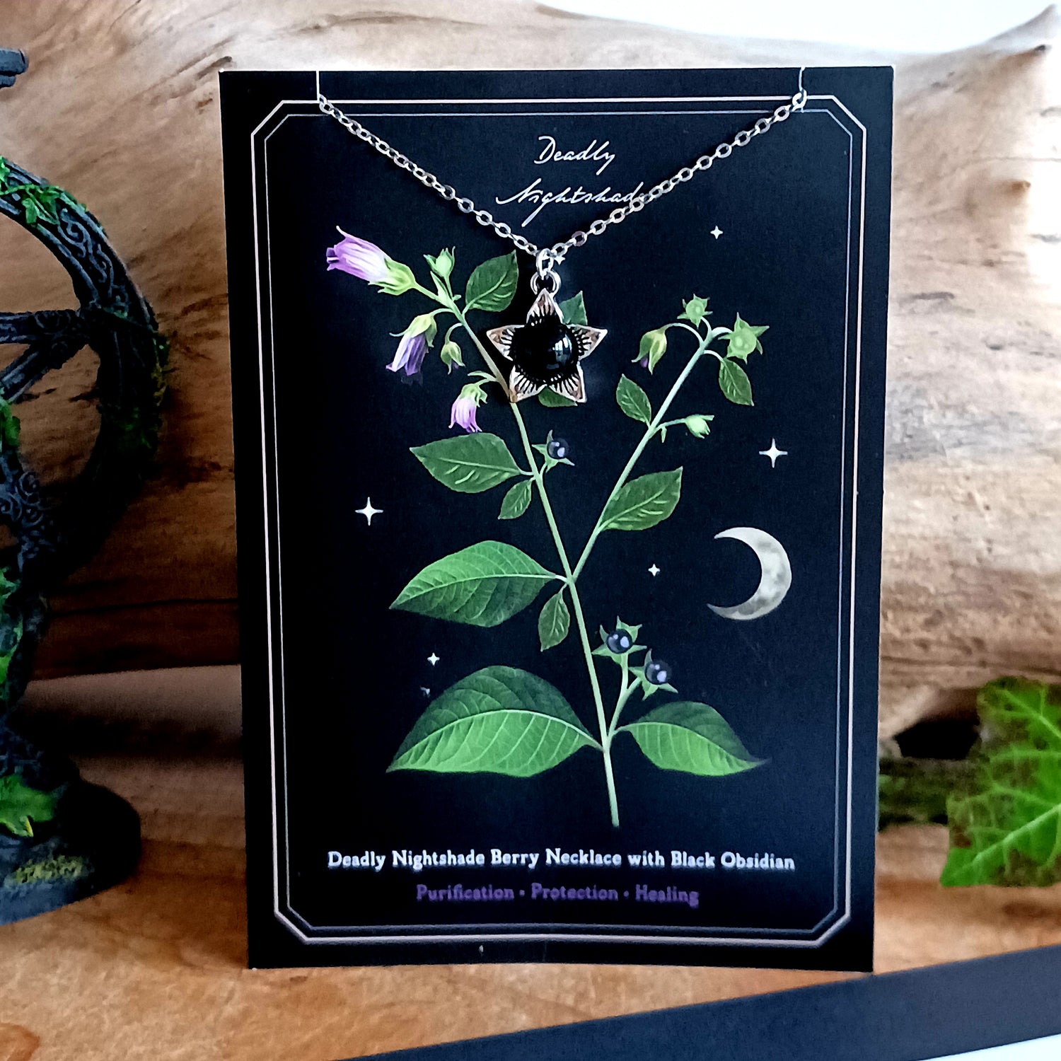 The Deadly Nightshade Necklace with Black Obsidian is a piece of dark elegance, blending nature’s shadowed beauty with gothic symbolism.