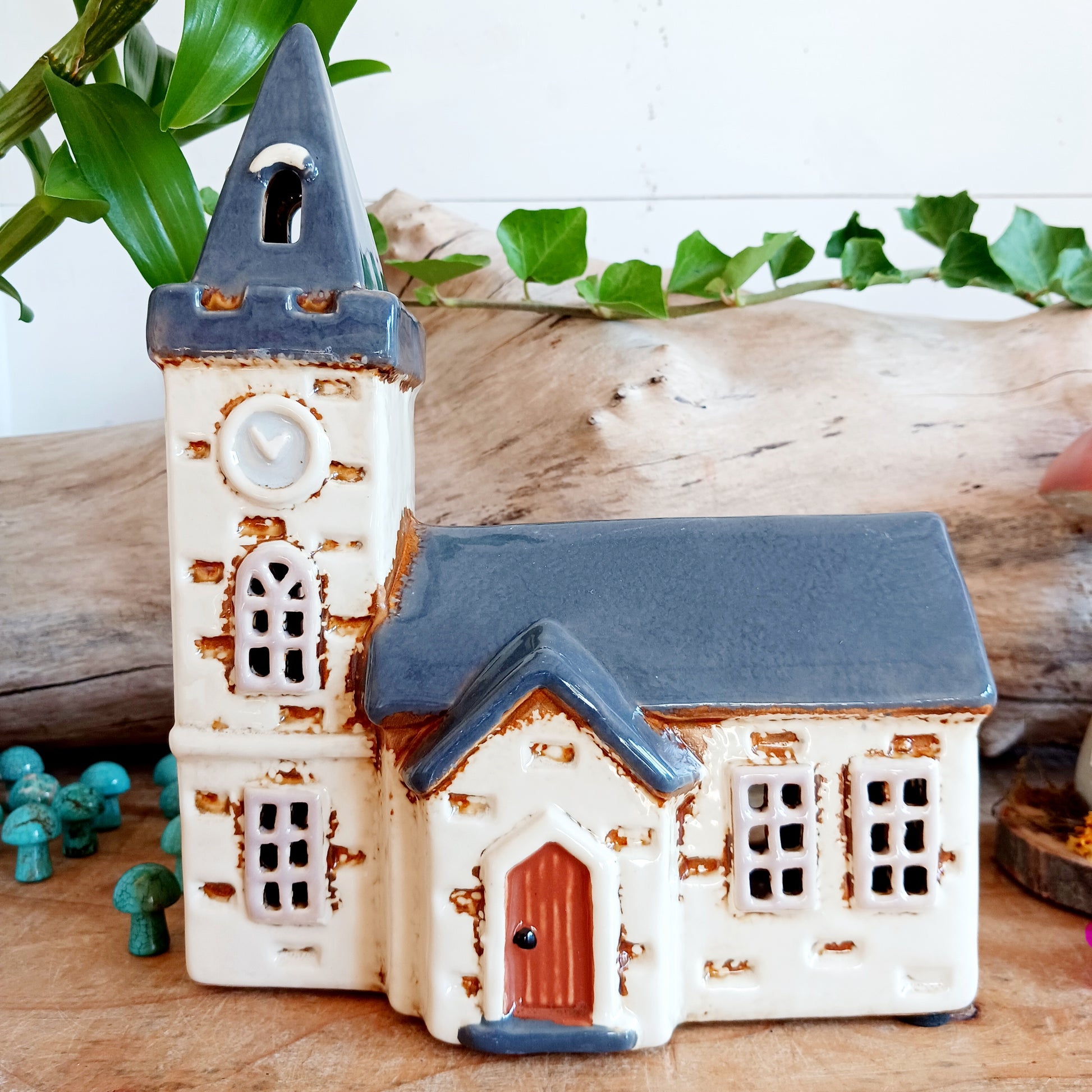 Add timeless charm to your home with the Village Pottery Steeple Church Tealight Holder. Beautifully hand-finished, each ceramic piece is unique and full of character. When a tealight is placed inside, a warm, cosy glow shines through the delicate church windows, creating a magical ambiance. 