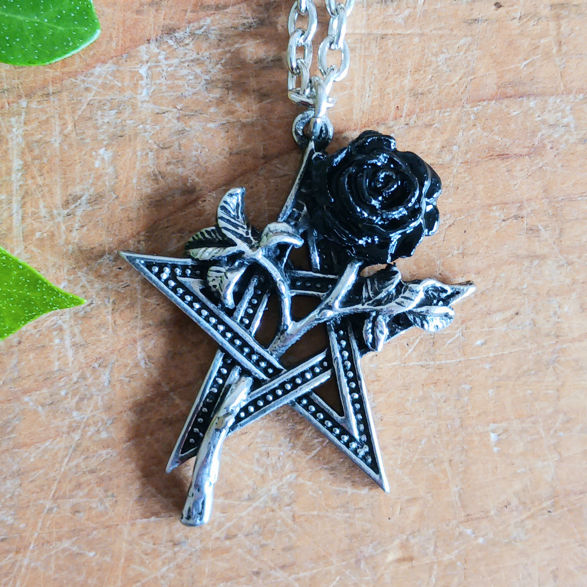 Embrace dark romance and mystical symbolism with this striking Alchemy England Gothic Pentagram and Black Rose Necklace. Featuring a detailed pewter pentagram entwined with a beautiful black-petalled rose, this distinctive gothic pendant combines spiritual symbolism with the timeless beauty of romantic gothic jewellery.