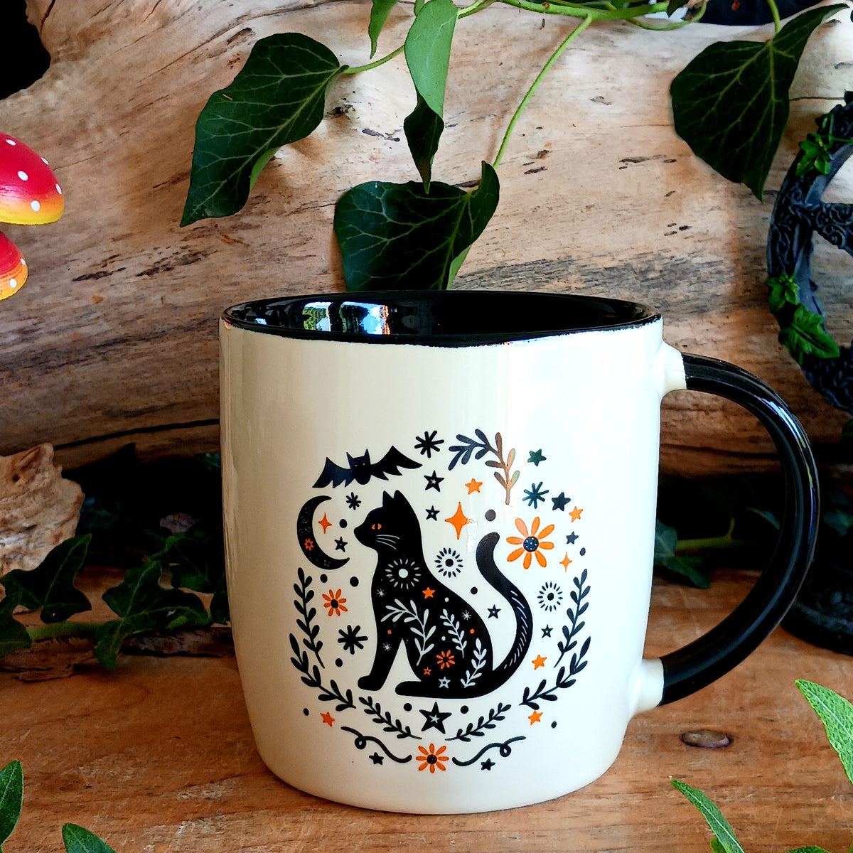 Enjoy cosy autumn moments with this charming black cat ceramic mug, decorated with a folk-inspired design. Perfect for enjoying your favourite tea, coffee or hot chocolate, this seasonal mug brings a warm and whimsical touch to your kitchen.