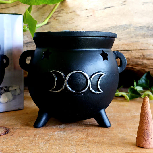 Create a mystical atmosphere in your space with this beautifully crafted Triple Moon Cauldron Incense Burner. Designed for both function and aesthetic appeal, this enchanting resin burner allows you to place an incense cone inside and watch as fragrant smoke gently rises through the top, creating a calming and magical ambiance.