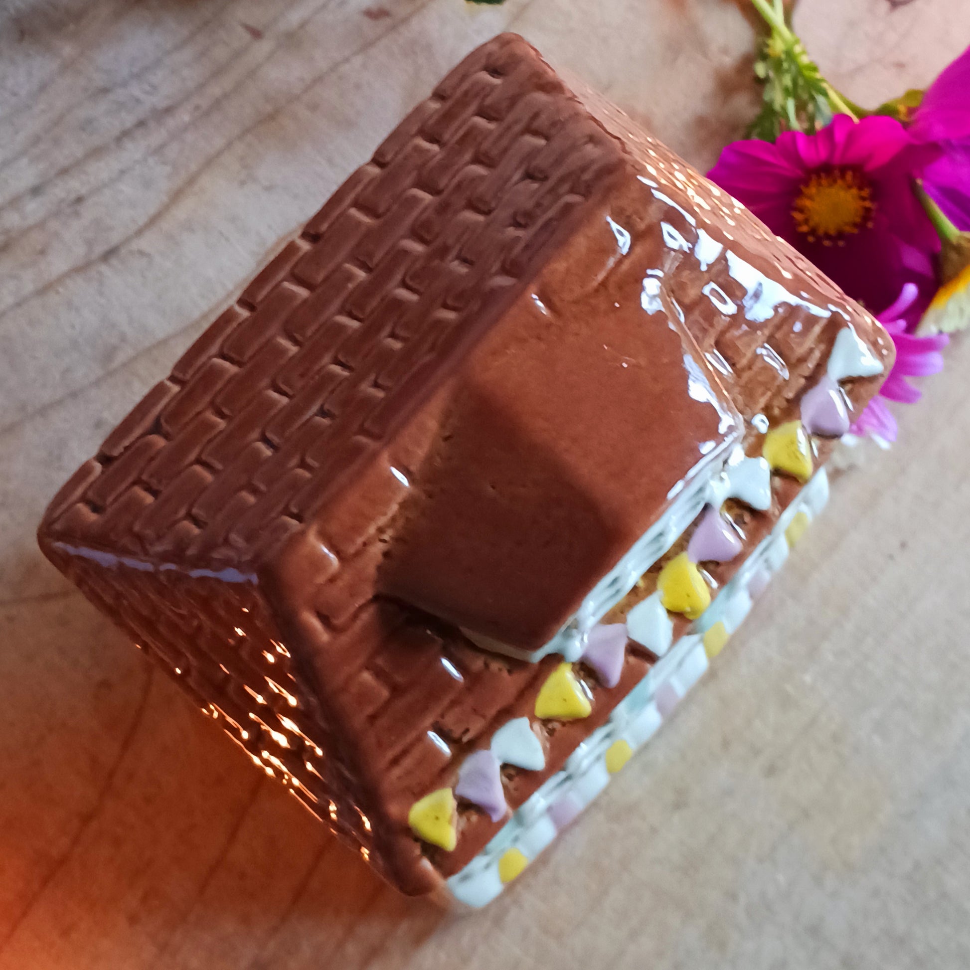 Handcrafted in the Village Pottery workshop, this Florist Tealight Holder is a true collectible from the Shudehill Collection. Made from fine ceramic with intricate detailing, it captures the nostalgic charm of a festive florist shop in a snow-dusted winter village scene.