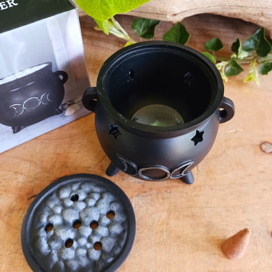 Create a mystical atmosphere in your space with this beautifully crafted Triple Moon Cauldron Incense Burner. Designed for both function and aesthetic appeal, this enchanting resin burner allows you to place an incense cone inside and watch as fragrant smoke gently rises through the top, creating a calming and magical ambiance.