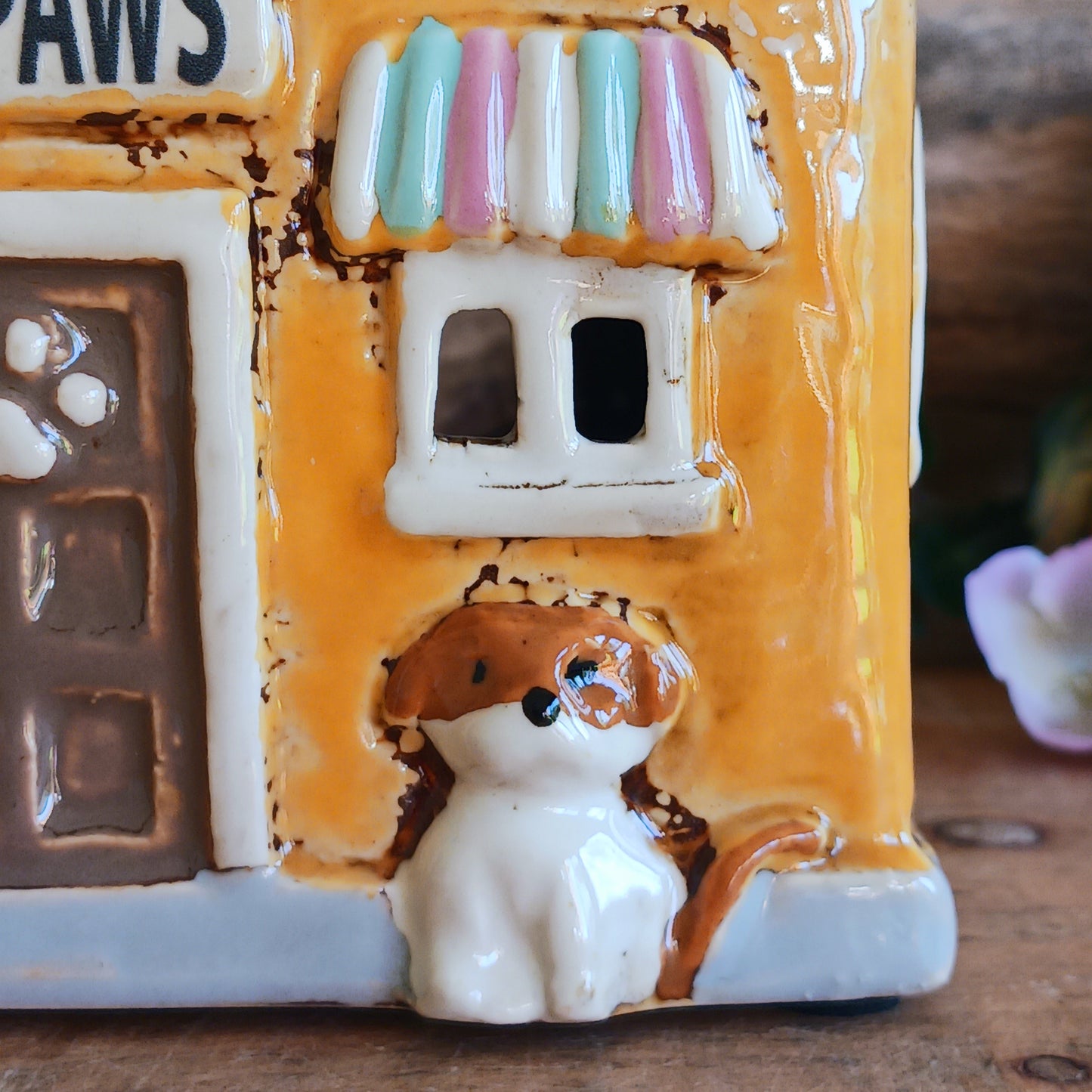 A gentle glow shines from Posh Paws, where tiny windows flicker with warmth as if welcoming beloved companions into a magical village haven. This Shudehill Village Pottery tealight house is crafted from ceramic, allowing candlelight to dance softly through its details, creating a comforting and enchanted atmosphere.