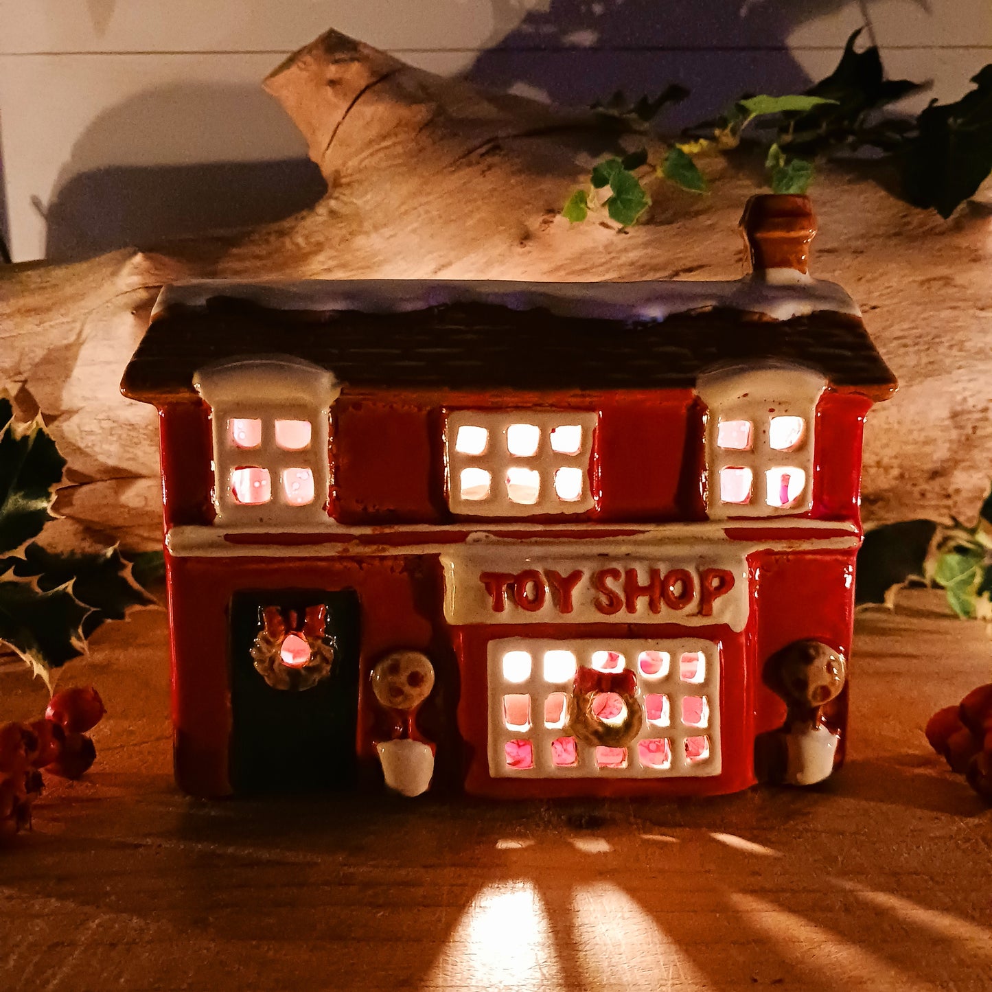 Bring nostalgic festive charm to your home with our Christmas Toy Shop Ceramic Tealight Holder, handcrafted in the Village Pottery workshop. This detailed tealight house captures the magic of an old-world toy shop on a snowy winter’s evening. 