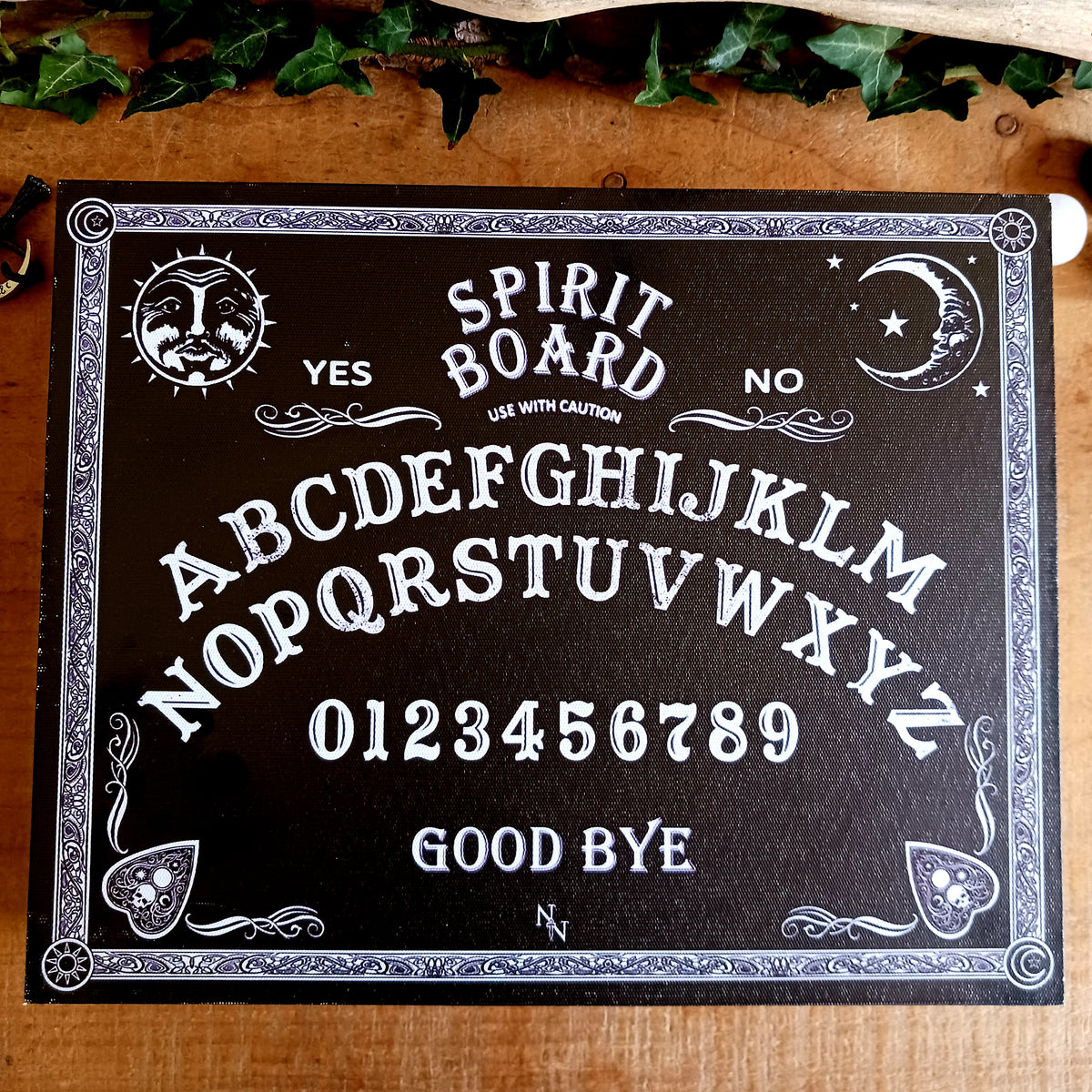 Add a touch of gothic and vintage occult style to your dressing table with this large spirit board jewellery box. Designed with a striking black background, white baroque artwork and traditional spirit-board-inspired details, it makes an unusual storage piece for anyone drawn to mystical and alternative décor.