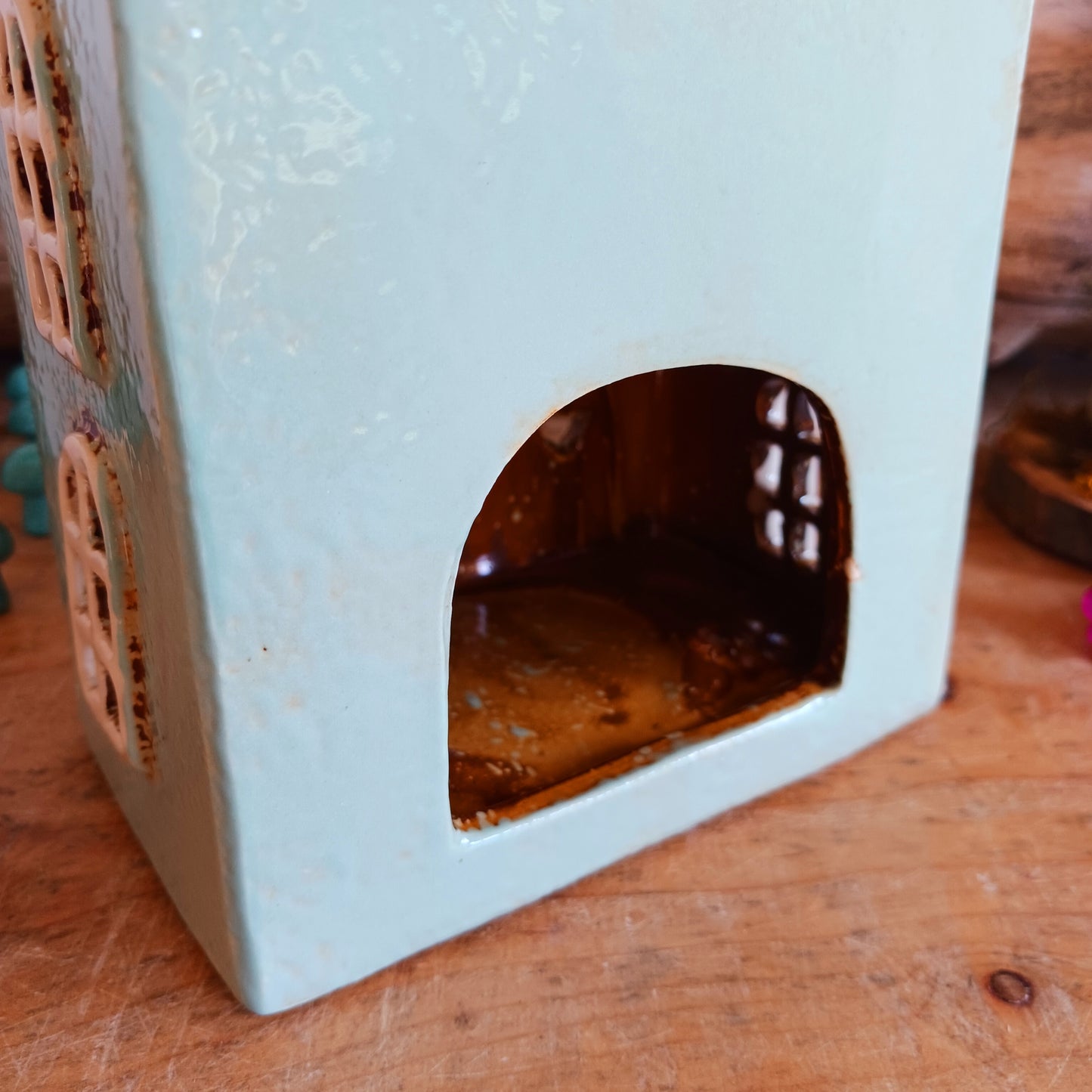 Transform your home into a warm and inviting sanctuary with the Village Pottery Gift Shop Tealight Holder. Crafted from quality ceramic, this charming piece creates a cosy, nostalgic glow when lit with a tealight. More than just a candle holder, it doubles as a delightful decorative ornament for your coffee table, shelf, or windowsill.