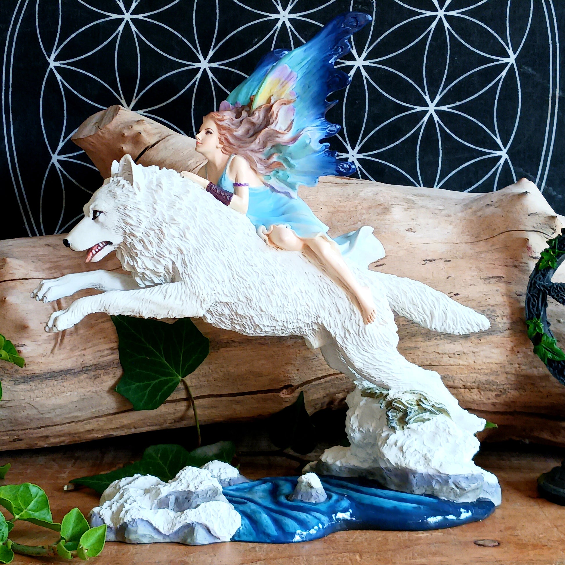 Bring a touch of magical fantasy to your home with this beautifully detailed Fairy Riding A White Wolf Statue from Nemesis Now. The dramatic figurine depicts a graceful fairy riding her loyal white wolf companion as they leap over a flowing stream, creating a striking sense of movement and adventure.