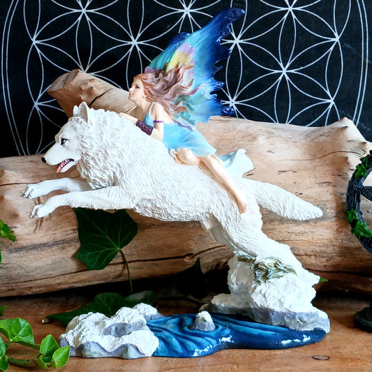 Bring a touch of magical fantasy to your home with this beautifully detailed Fairy Riding A White Wolf Statue from Nemesis Now. The dramatic figurine depicts a graceful fairy riding her loyal white wolf companion as they leap over a flowing stream, creating a striking sense of movement and adventure.