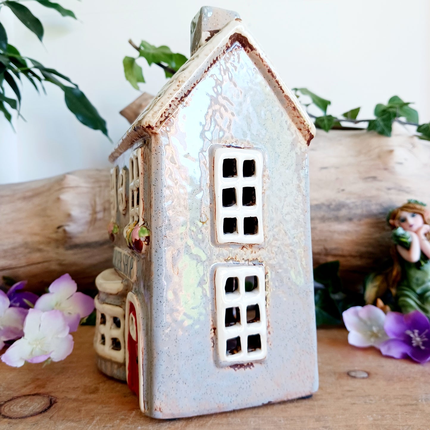 At the heart of an enchanted street stands the Corner Shop, its windows glowing softly as if lit by unseen hands. This Shudehill Village Pottery tealight house is crafted from ceramic to capture the quiet magic of village life, where candlelight flickers like whispered exchanges between worlds.