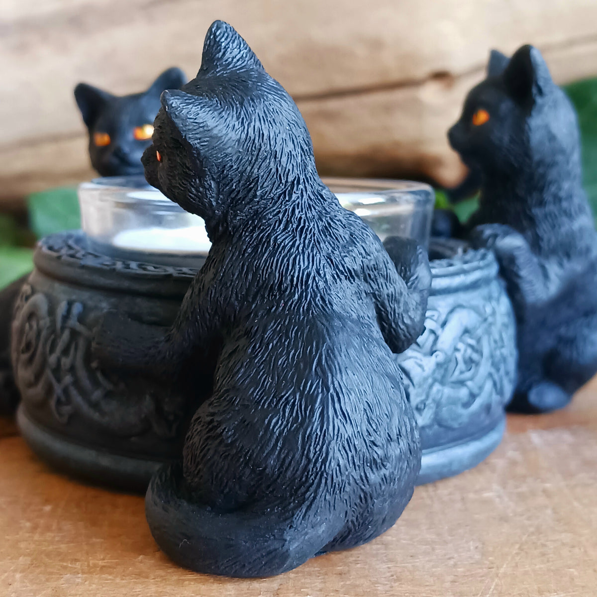 Bring a touch of playful witchcraft and gothic charm into your home with the Familiar Trio Tea Light Holder. Featuring three mischievous black cat familiars gathered around a central tealight, this enchanting candle holder creates a warm and atmospheric glow with plenty of magical character.