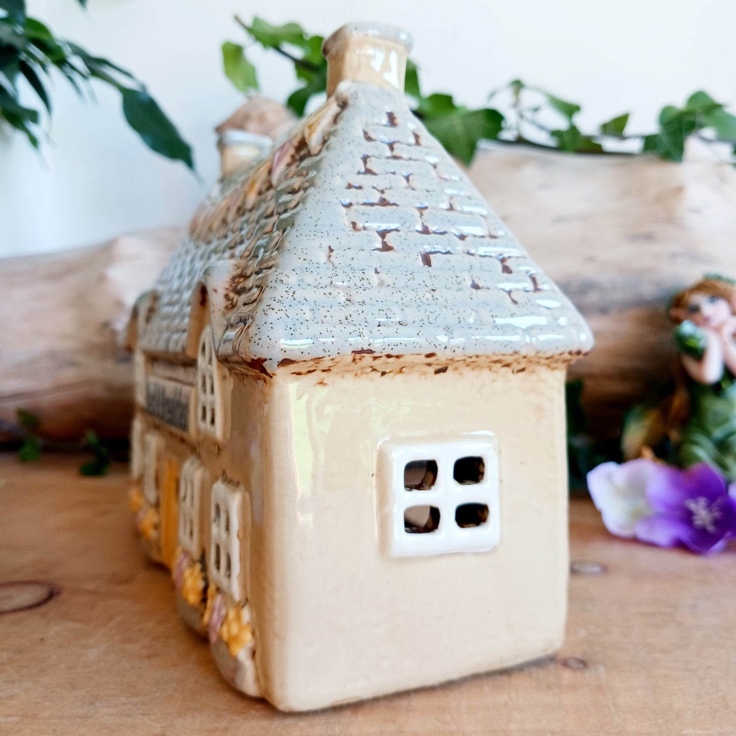 A welcoming glow awaits within this Village Pottery Bed & Breakfast Tealight House, where candlelight flickers through tiny windows like a hearth lit for wandering souls. Crafted from ceramic, this charming inn captures the spirit of an enchanted village, inviting warmth, stillness, and quiet magic into your space.