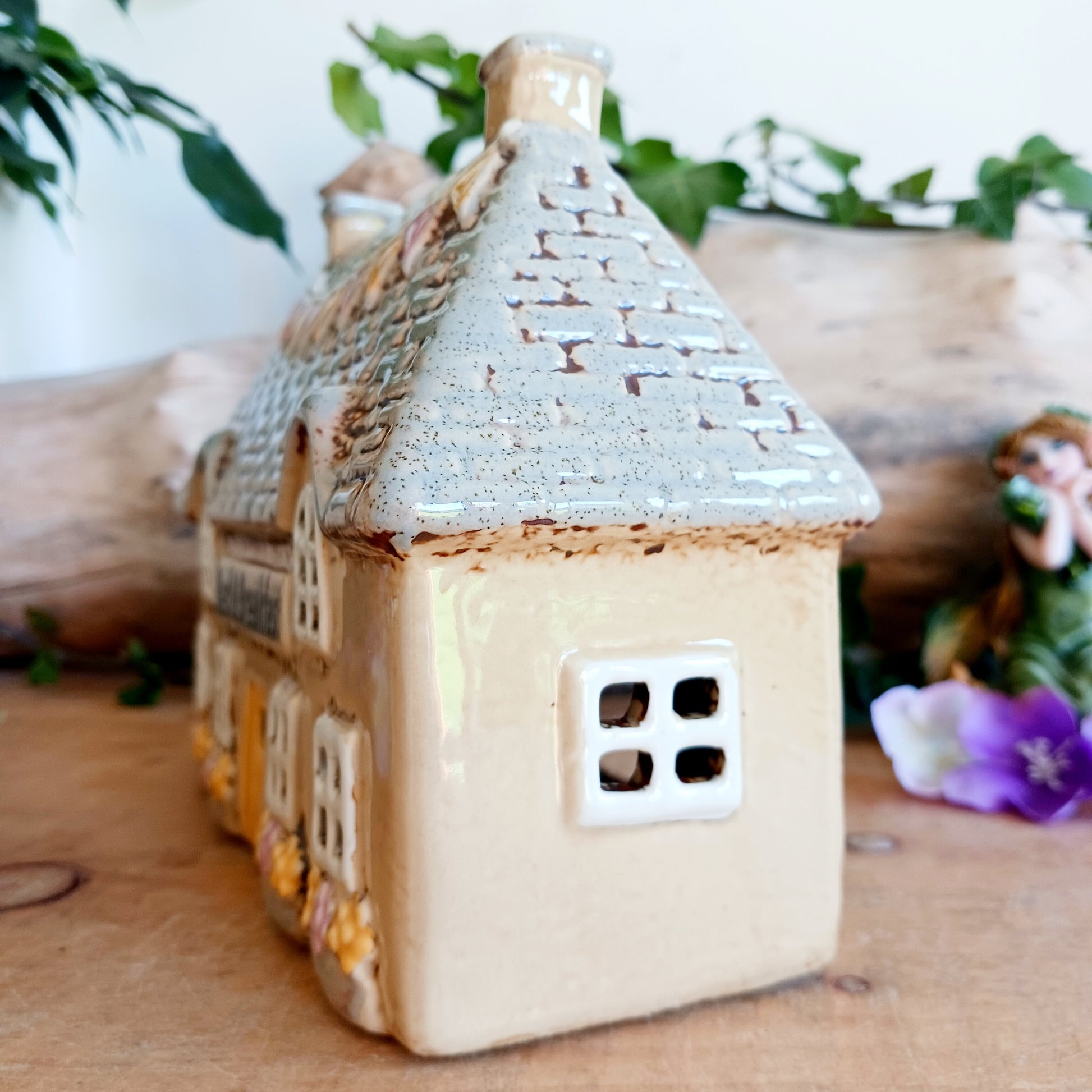 A welcoming glow awaits within this Village Pottery Bed & Breakfast Tealight House, where candlelight flickers through tiny windows like a hearth lit for wandering souls. Crafted from ceramic, this charming inn captures the spirit of an enchanted village, inviting warmth, stillness, and quiet magic into your space.