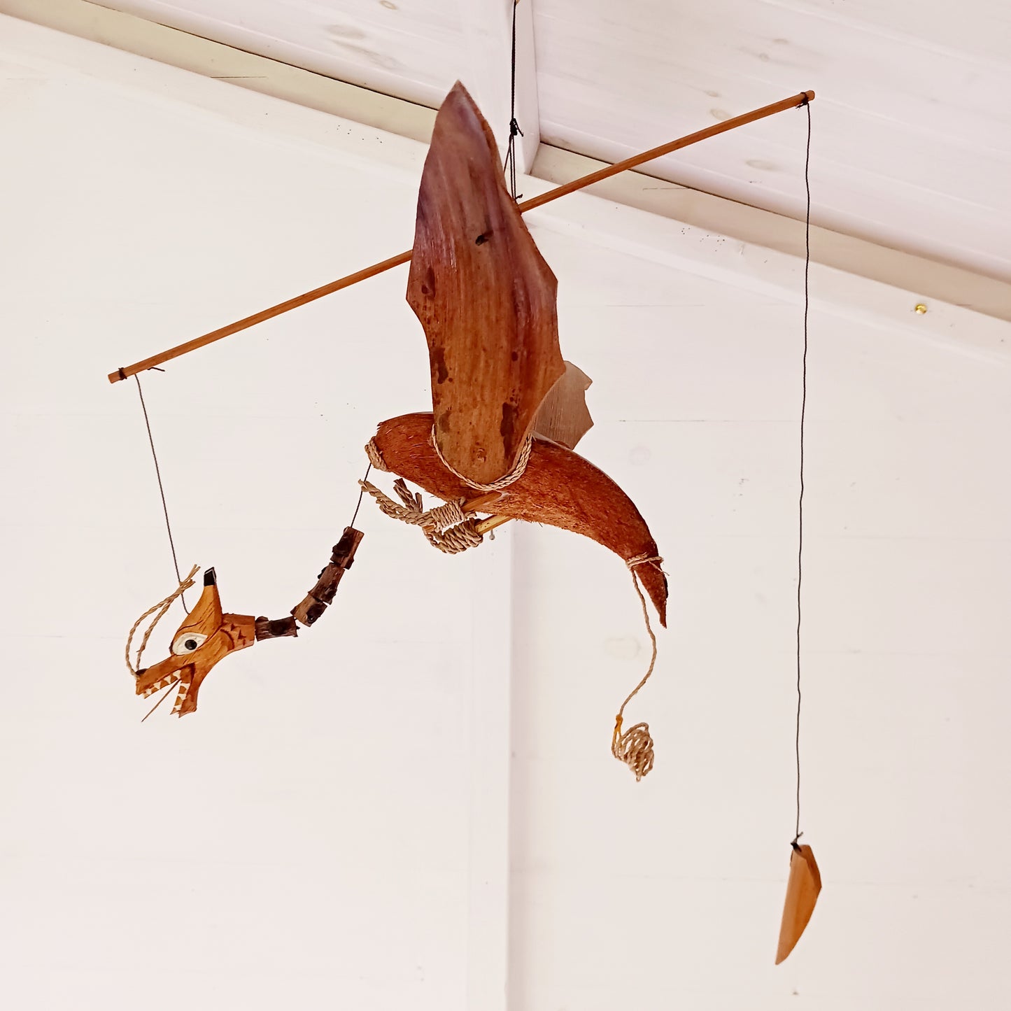 Add a touch of fantasy and natural craftsmanship to your home or garden with this Handmade Coconut Shell Flying Dragon Hanging Mobile. Carefully crafted from real coconut shells, husks, and wood, this unique decorative piece brings movement and character wherever it hangs.