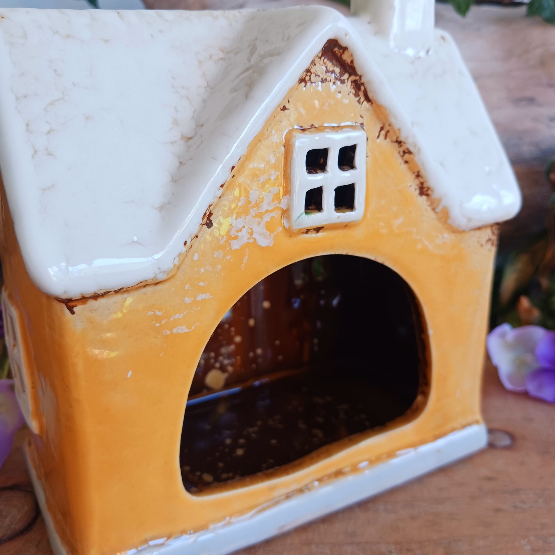 A gentle glow shines from Posh Paws, where tiny windows flicker with warmth as if welcoming beloved companions into a magical village haven. This Shudehill Village Pottery tealight house is crafted from ceramic, allowing candlelight to dance softly through its details, creating a comforting and enchanted atmosphere.