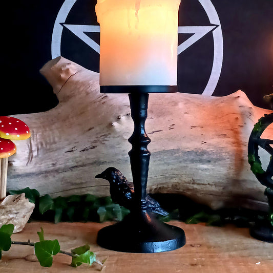 The Mystic Raven Pillar Candle Holder is a striking gothic statement piece, featuring a dramatic raven perched upon an ornate, gothic-inspired base. 