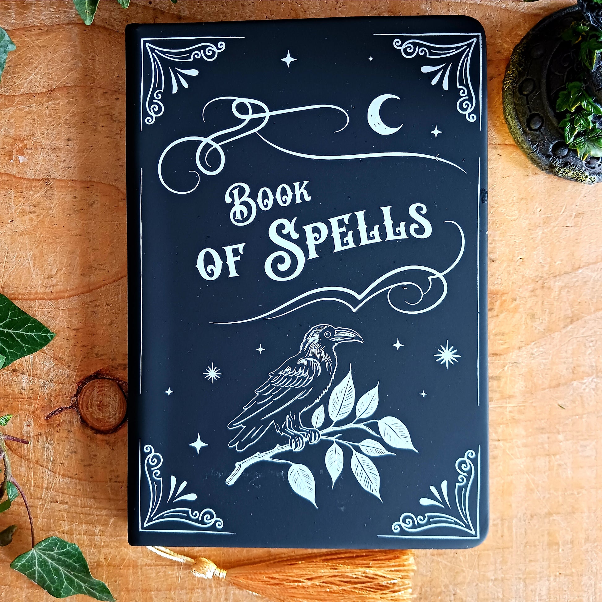 Capture your thoughts, spells, stories, or midnight musings in this beautifully styled&nbsp;A5 “Book of Spells” notebook. Designed with a gothic, mystical aesthetic, this notebook feels like it came straight from a wizard’s library—perfect for writers, witches, creatives, and lovers of dark academia stationery.