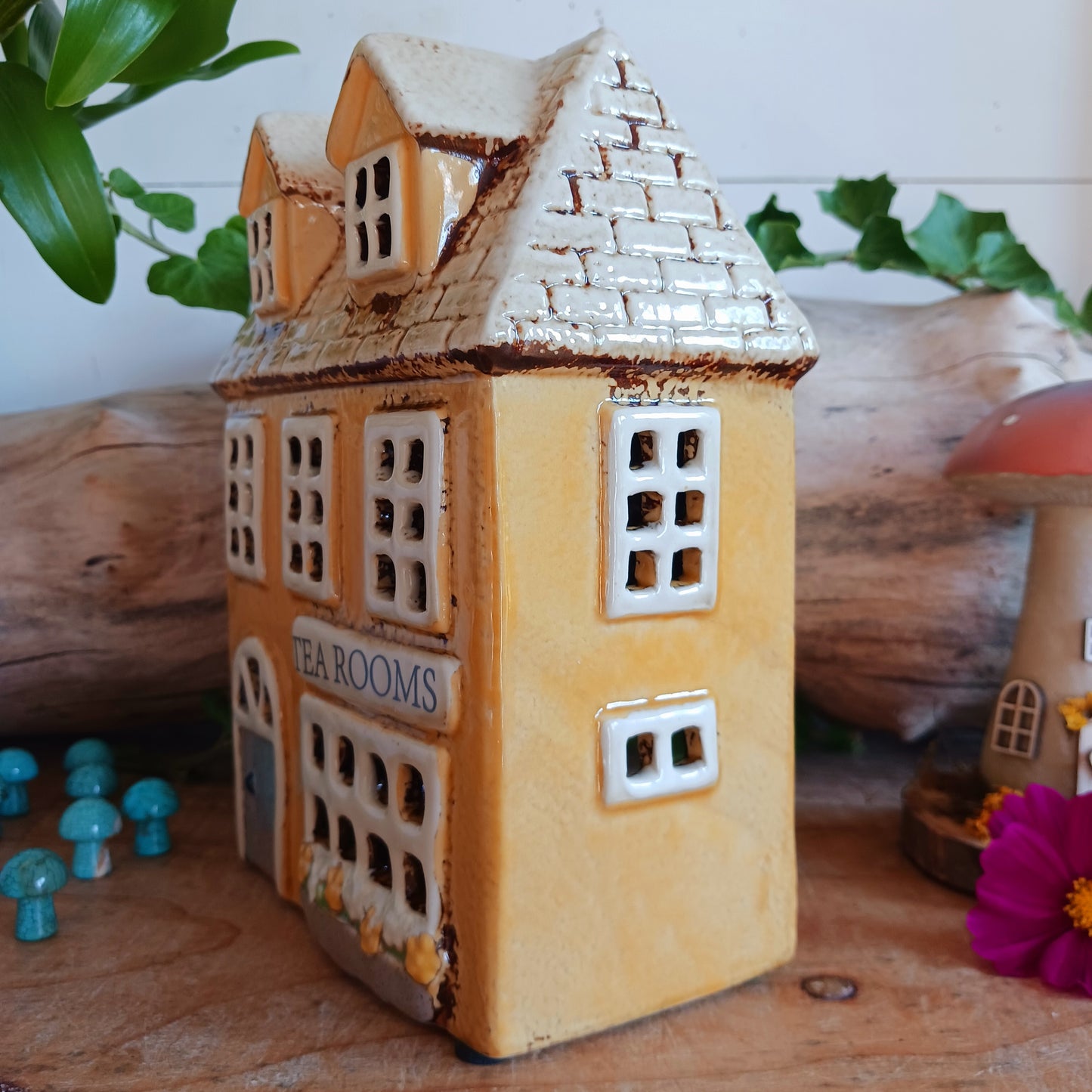 Transform your home into a warm and inviting sanctuary with the Village Pottery Tea Rooms Tealight Holder. Crafted from quality ceramic, this charming rustic piece creates a cosy, nostalgic glow when lit with a tealight. More than just a candle holder, it doubles as a delightful decorative ornament for your coffee table, shelf, or windowsill. 