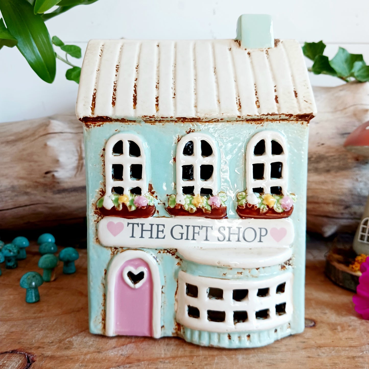 Transform your home into a warm and inviting sanctuary with the Village Pottery Gift Shop Tealight Holder. Crafted from quality ceramic, this charming piece creates a cosy, nostalgic glow when lit with a tealight. More than just a candle holder, it doubles as a delightful decorative ornament for your coffee table, shelf, or windowsill.
