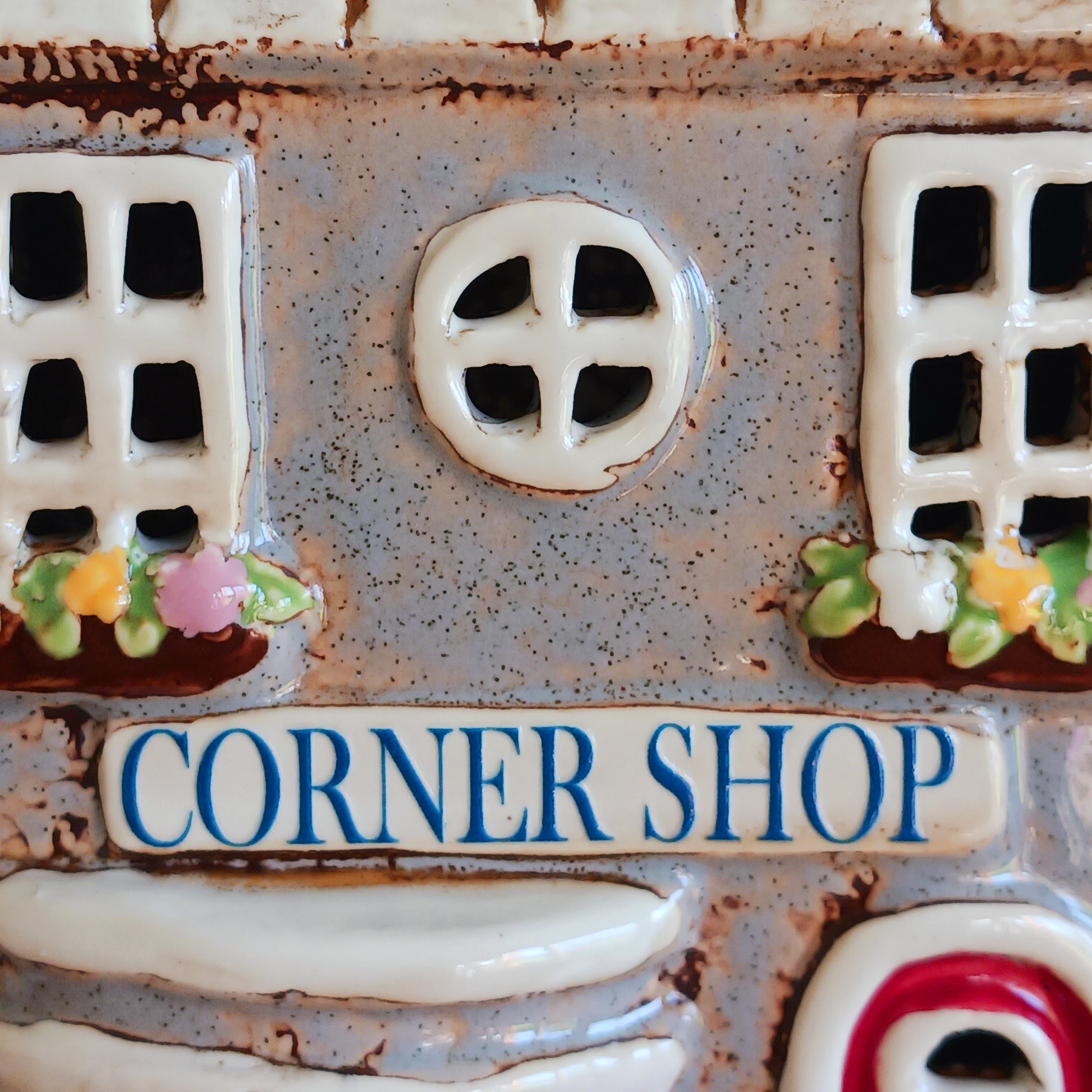 At the heart of an enchanted street stands the Corner Shop, its windows glowing softly as if lit by unseen hands. This Shudehill Village Pottery tealight house is crafted from ceramic to capture the quiet magic of village life, where candlelight flickers like whispered exchanges between worlds.