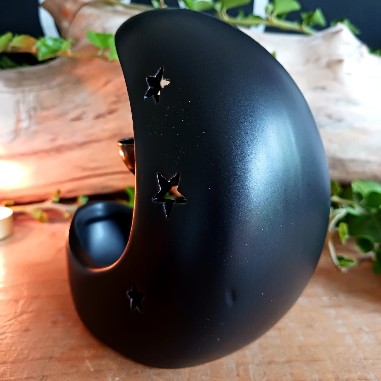 Bring a touch of midnight magic to your home with this enchanting black crescent moon oil burner. Crafted with celestial star cut-outs, it casts a soft, glowing light while infusing the air with your favorite fragrance oil. The hanging bowl design adds a whimsical charm, making it perfect for creating a cozy, dreamy atmosphere in any space. Ideal for relaxing evenings, meditation, or simply adding a mystical statement piece to your décor.