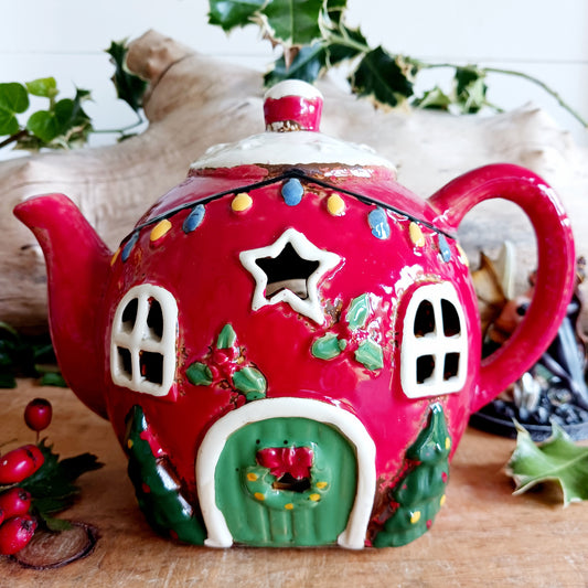 Add a touch of charm and character to your festive display with the Village Pottery Xmas Teapot House Tealight. Combining the familiar shape of a traditional teapot with the appearance of a miniature Christmas house, this unusual decorative tealight holder makes a delightful addition to your seasonal décor.