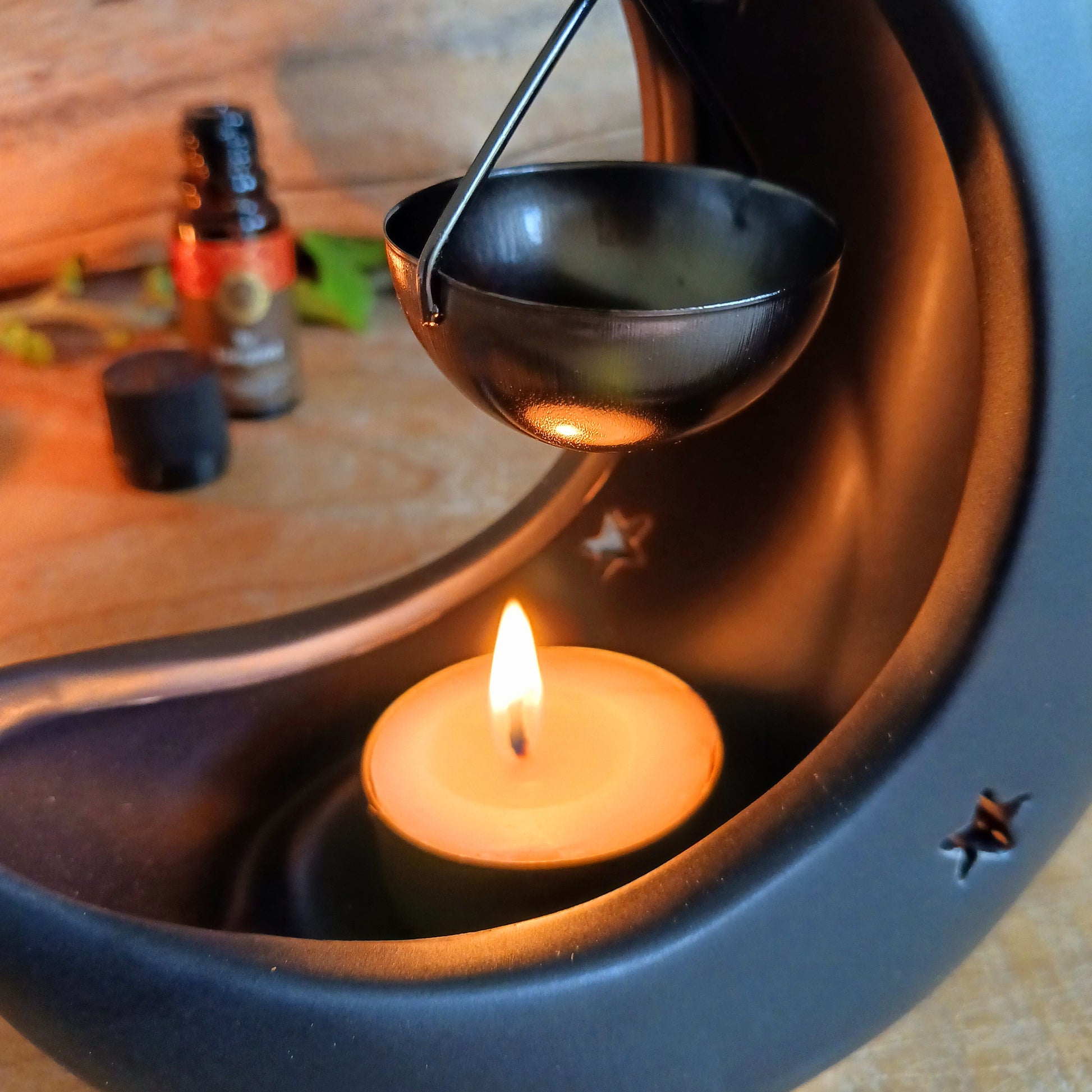 Bring a touch of midnight magic to your home with this enchanting black crescent moon oil burner. Crafted with celestial star cut-outs, it casts a soft, glowing light while infusing the air with your favorite fragrance oil. The hanging bowl design adds a whimsical charm, making it perfect for creating a cozy, dreamy atmosphere in any space. Ideal for relaxing evenings, meditation, or simply adding a mystical statement piece to your décor.