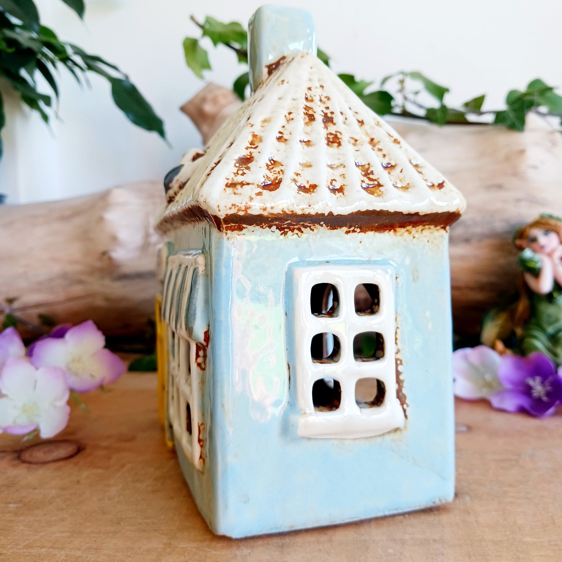 A warm, golden glow spills from the windows of this Village Pottery Chippy, where the spirit of a bustling village meets quiet enchantment. Crafted from ceramic, this Shudehill tealight house captures a familiar yet mystical charm, as candlelight flickers like stories shared after dusk.