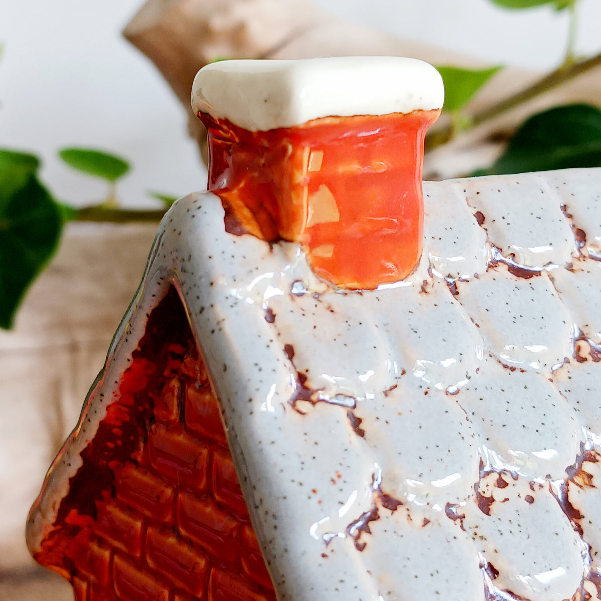 Bring a touch of village charm to your home with the Village Pottery Newsagent Tealight Holder. Beautifully designed as a traditional little village newsagent, this charming ceramic tealight holder features a warm red-brick façade, textured cream tiled roof and cheerful bright red front door.