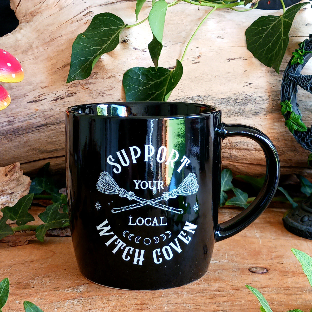 Show your support for all things magical with this stylish Support Your Local Witch Coven mug. Made from black ceramic and featuring crossed broomsticks with the phrase “Support Your Local Witch Coven”, it’s a fun and eye-catching choice for modern witches, witchy souls and lovers of mystical style.