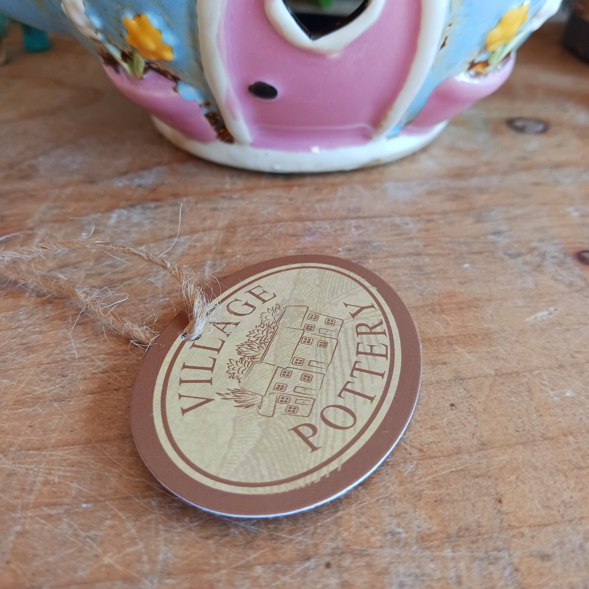 Create a warm and cosy atmosphere in your home with this charming Round Teapot Tealight Holder from the Village Pottery Collection. Crafted in a unique teapot shape, this ceramic tealight holder makes a delightful decorative piece for shelves, windowsills, or side tables. Simply place a tealight inside to enjoy a soft, glowing ambience.