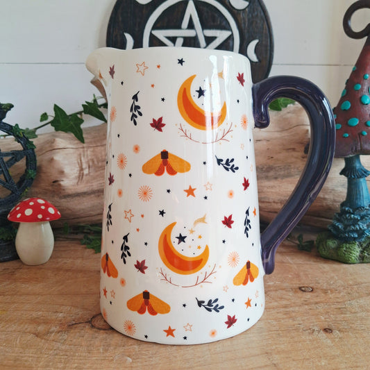 This ivory ceramic jug features a graceful harvest moon design with leaves and golden accents, making it perfect for displaying fresh flowers or dried arrangements. A lovely gift for fans of seasonal decor or as a stunning centrepiece for autumn gatherings.