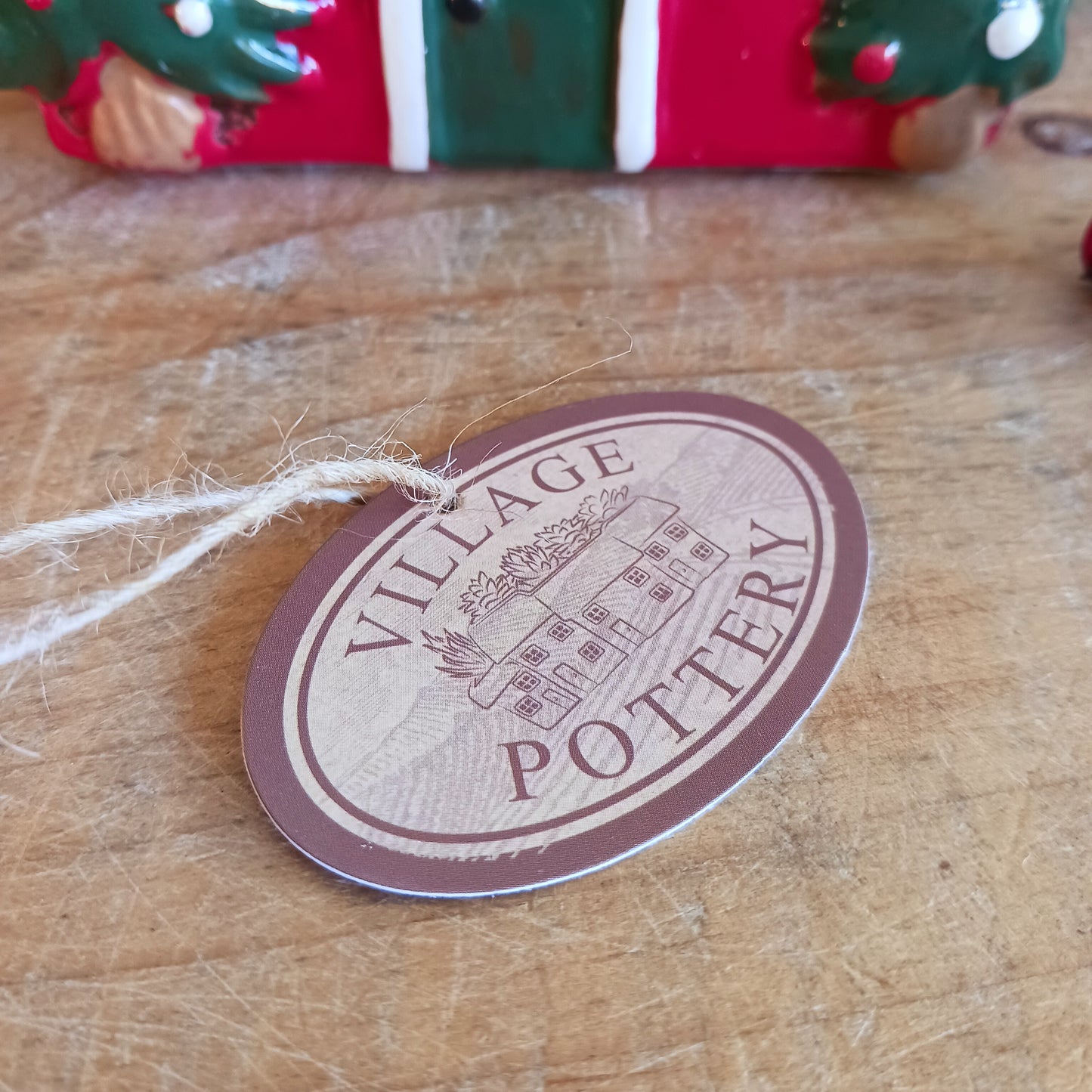 Bring timeless festive charm into your home with the Village Pottery Christmas Thatched Roof House Tealight Holder, a handcrafted ceramic cottage glowing with the spirit of the season. Measuring 17 x 12.5 x 8.5 cm, this enchanting piece captures the essence of a peaceful winter’s night — where golden candlelight flickers through snowy windows beneath a soft thatched roof.