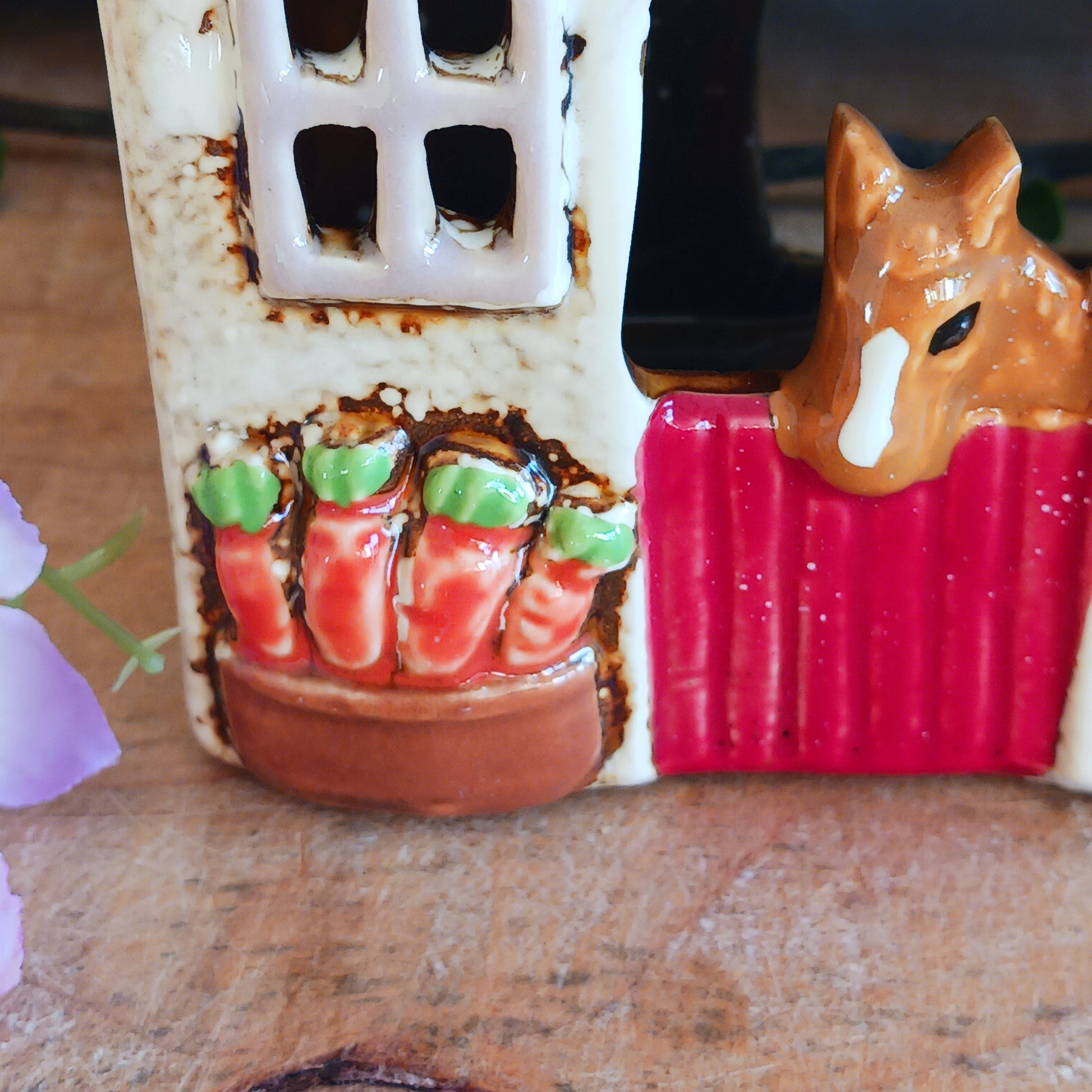 Nestled at the edge of a quiet enchanted village, The Stables tealight house by Village Pottery glows with a soft, grounding warmth. Crafted from ceramic and measuring 17x8x8cm, this rustic stable invites candlelight to flicker through its windows like a lantern for wandering spirits and kindred souls.
