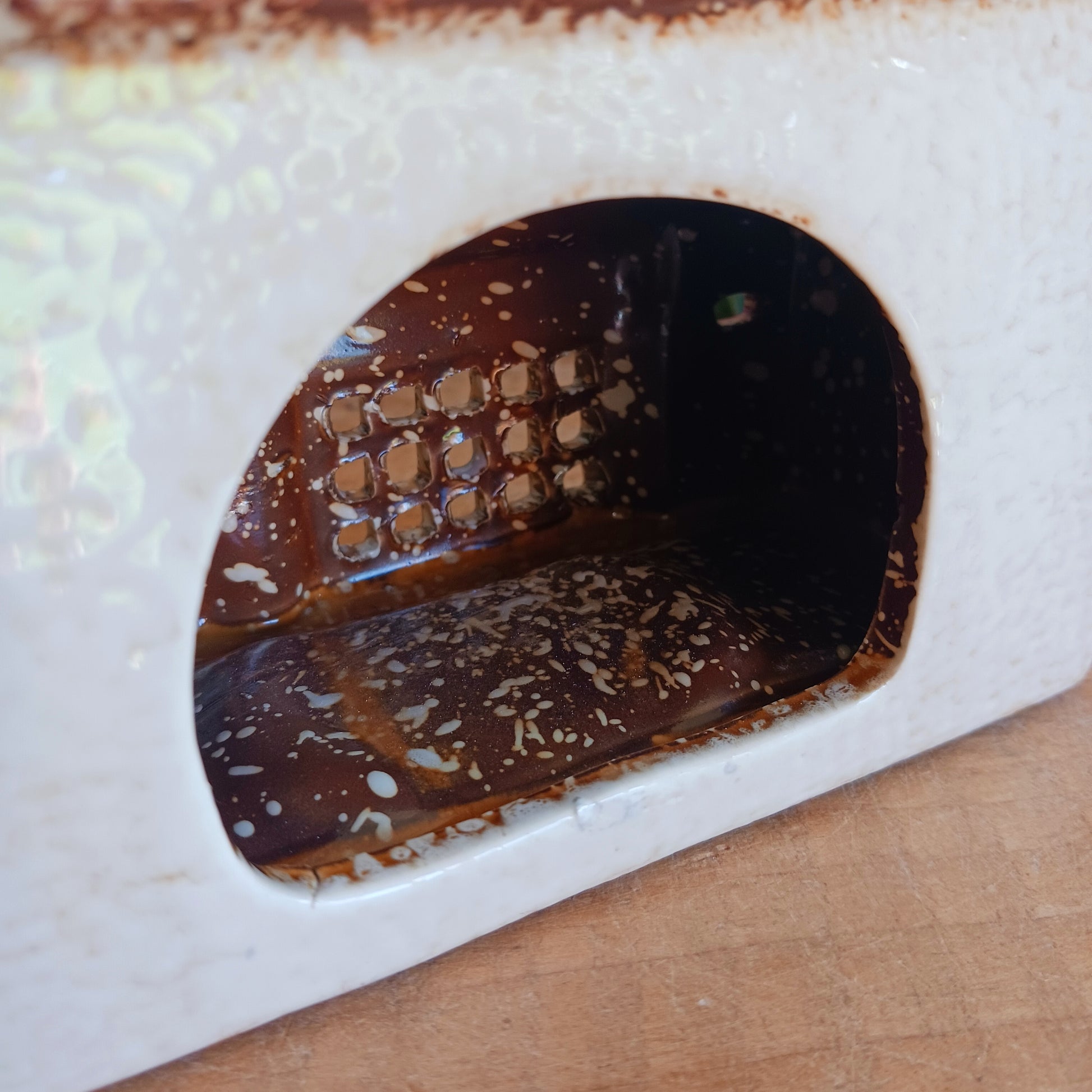 Whispers travel by candlelight from this Village Pottery Post Office tealight house, where tiny windows glow like messages carried between realms. Crafted from ceramic and measuring 12x15x7cm, this enchanting piece brings warmth and quiet magic to your sacred space.