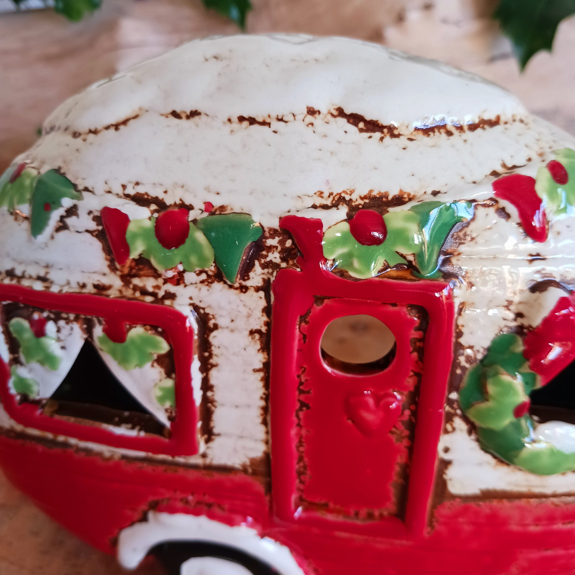 Step into a cosy winter wonderland with the Village Pottery Christmas Caravan Tealight Holder, a heart-warming piece crafted with love and festive magic. Measuring 13.5 x 18.5 x 7 cm, this hand-painted ceramic caravan glows with Christmas cheer, ready to light up your home with a gentle, enchanting flicker.