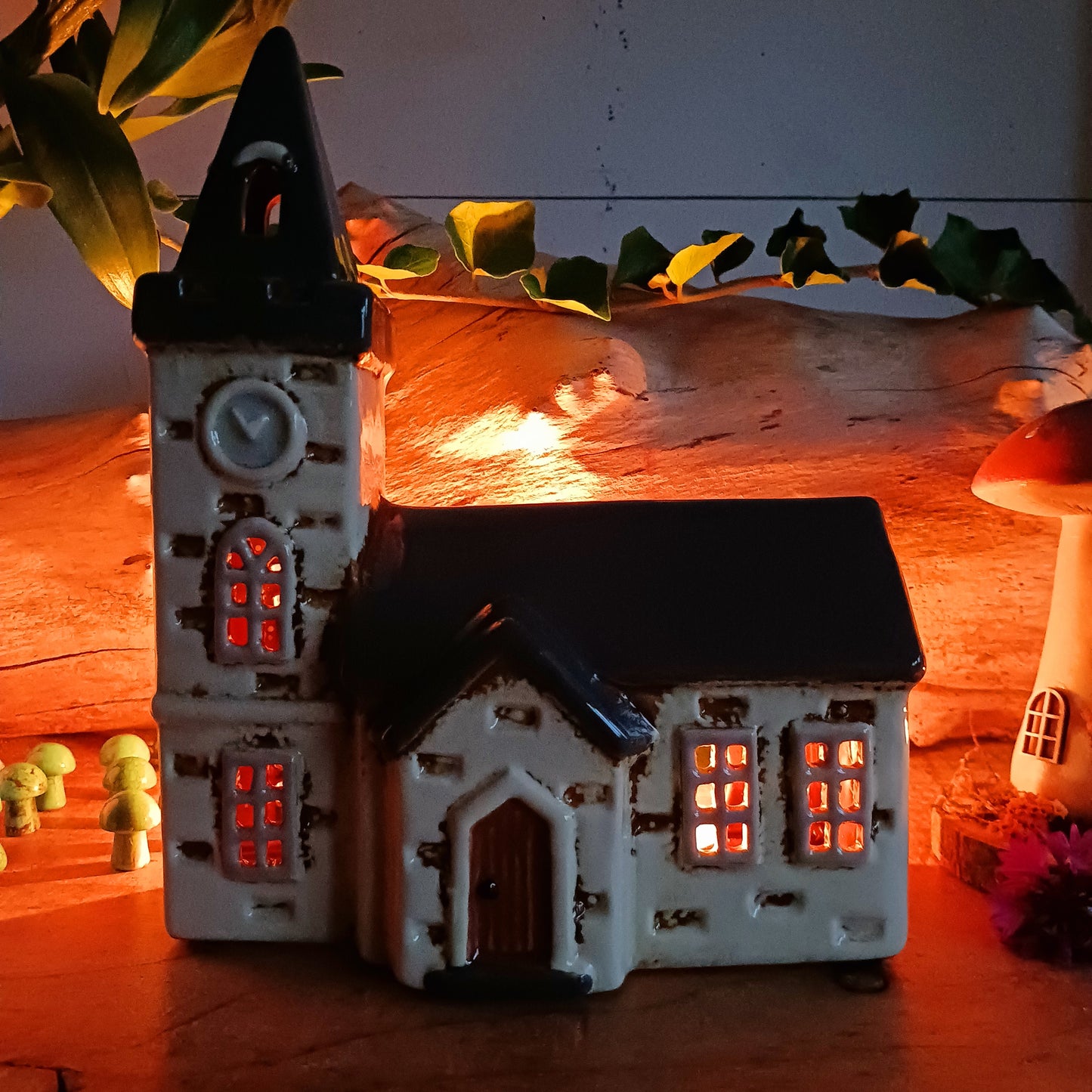 Add timeless charm to your home with the Village Pottery Steeple Church Tealight Holder. Beautifully hand-finished, each ceramic piece is unique and full of character. When a tealight is placed inside, a warm, cosy glow shines through the delicate church windows, creating a magical ambiance.