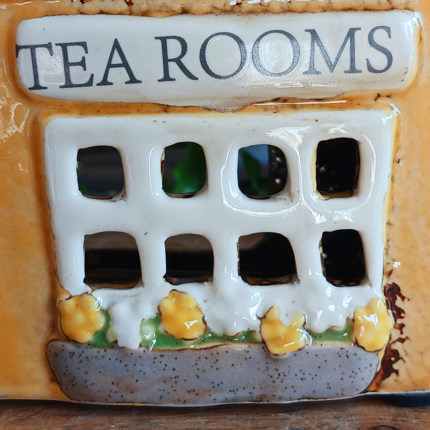 Transform your home into a warm and inviting sanctuary with the Village Pottery Tea Rooms Tealight Holder. Crafted from quality ceramic, this charming rustic piece creates a cosy, nostalgic glow when lit with a tealight. More than just a candle holder, it doubles as a delightful decorative ornament for your coffee table, shelf, or windowsill. 